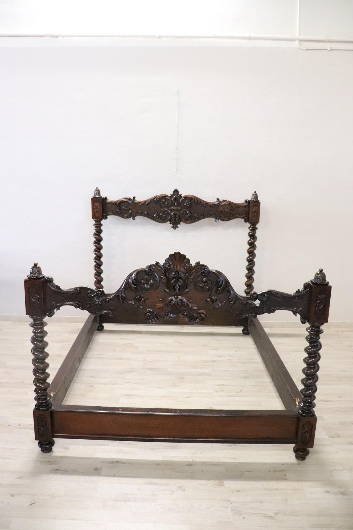 Beautiful antique Italian bed 1880s in walnut with finely carved decorations. Imposing twisted columns make this bed majestic. Perfect condition, restored. The measurements shown are outside the internal are cm 147 x 192. 
 