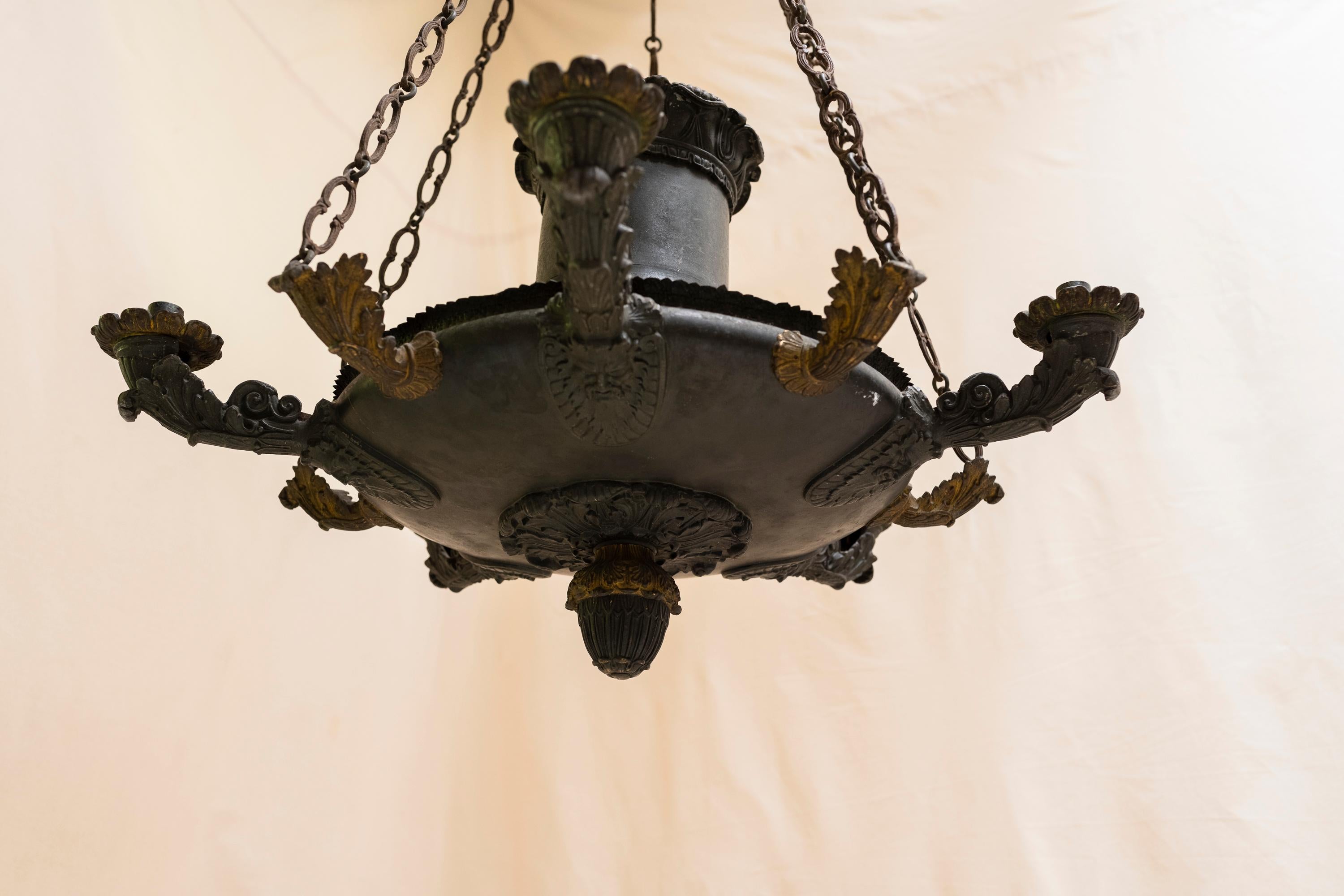 This beautiful oil chandelier remains in its original condition, and features a glorious patina. 
This chandelier hung in the study of a chateau for nearly 200 years, and has never been electrified. It can be used decoratively or may be wired for