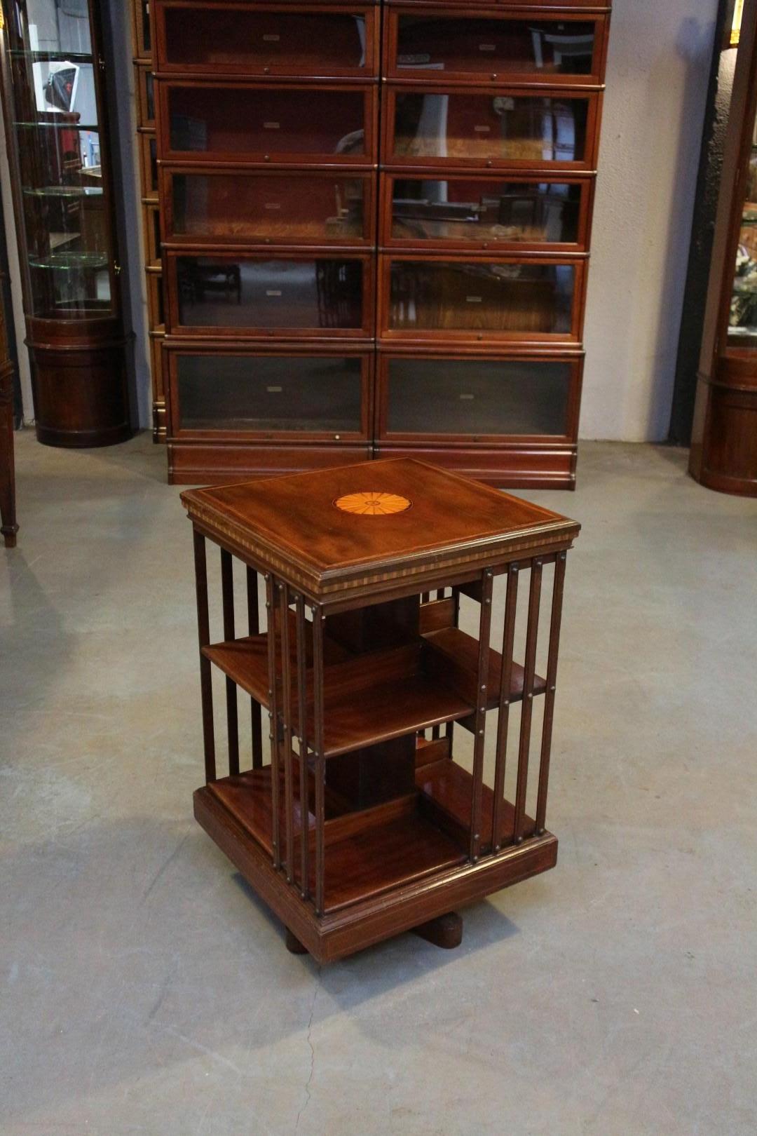 Beautiful antique mahogany book mill with particularly beautiful marquetry. Inlaid with satin wood. Super quality book mill from the famous English 19th century furniture maker Maple & Co. with the characteristic cast iron base. Nice color and