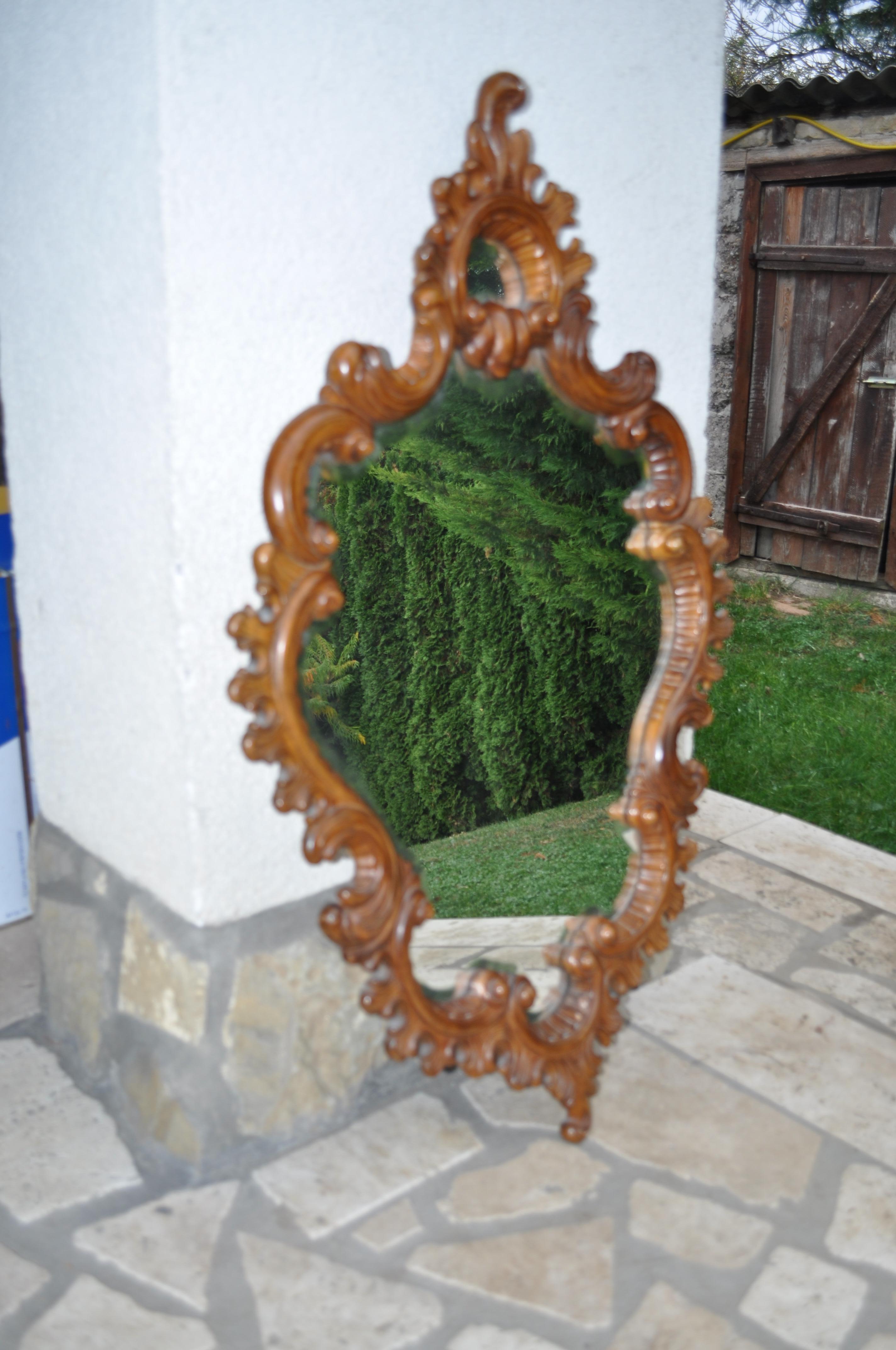 Solid wood carved frame.
 Entire body decorated with rocaille ornaments.
