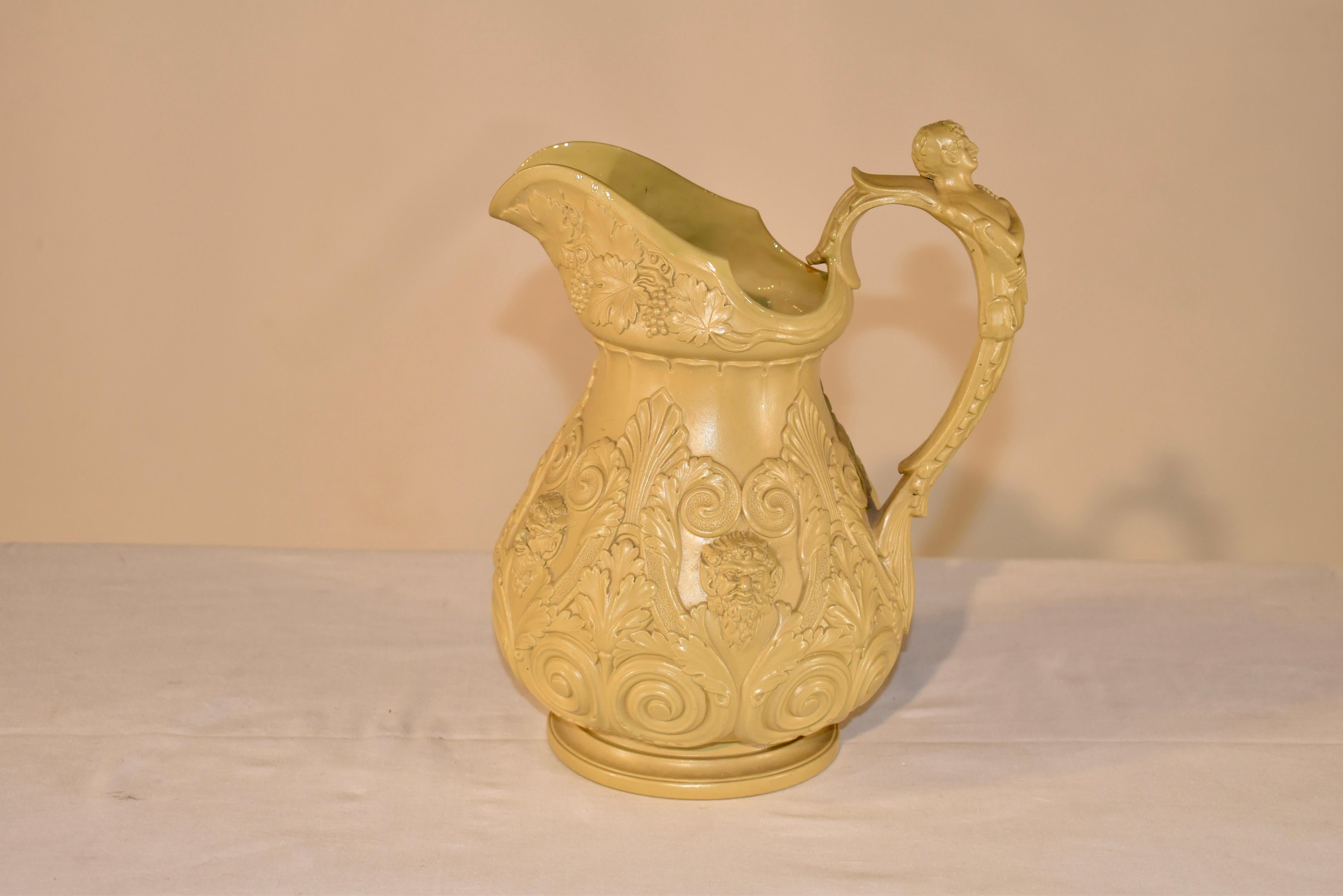 Early 19th century drab ware pitcher attributed to W. Ridgway & Co. Hanley. This is a wonderful wine jug with the most wonderfully and crisply relieved decoration with Bacchus and grape leaves, vines, and grapes. The handle is spectacularly molded