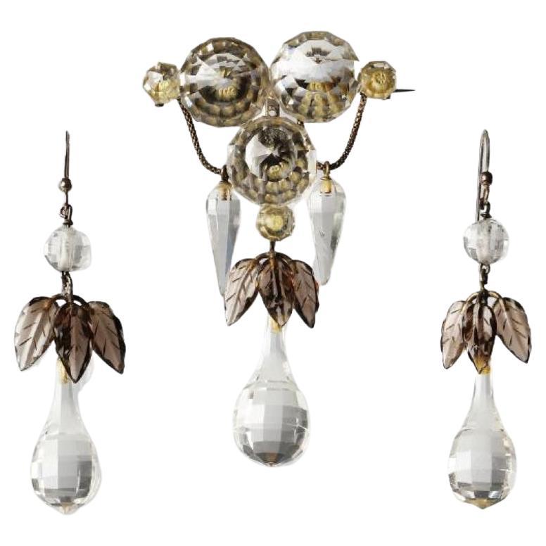 his unusual and lovely victorian set of faceted rock crystals and carved smoky quartz was made in the second half of the 19th century.

Natural rock crystals are saluted for its way of bending the light into a “pool” of light around the wearer. They