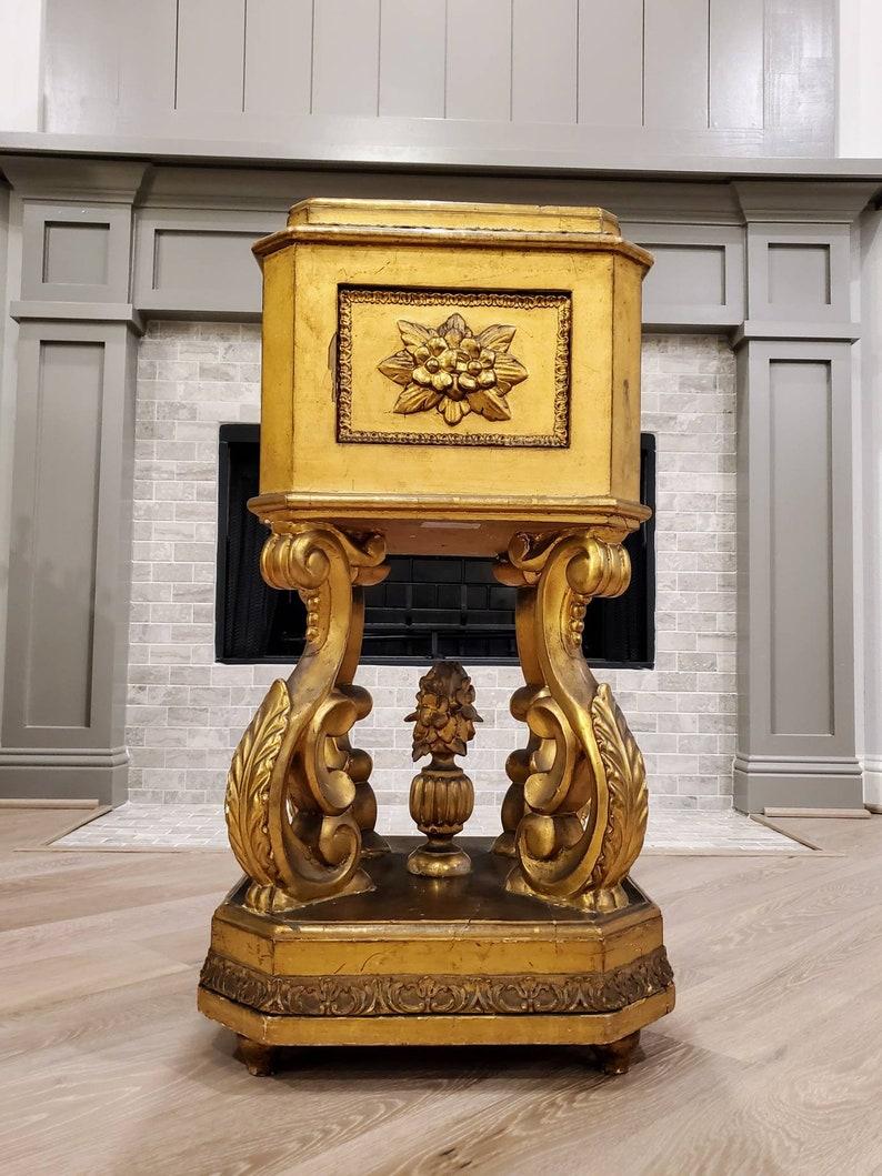 A 19th century Italian late Baroque elaborately carved giltwood pedestal stand from the estate of legendary American businessman, T. Boone Pickens. 

Exceptionally executed, exotic, highly unusual in form, hand carved, decadent gilded bronze -