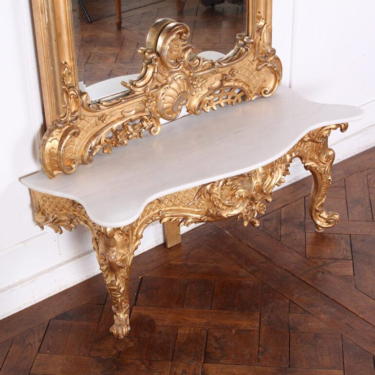 A 19th century highly-carved and gilt Rococo-style pier mirror and original marble top serpentine console table.