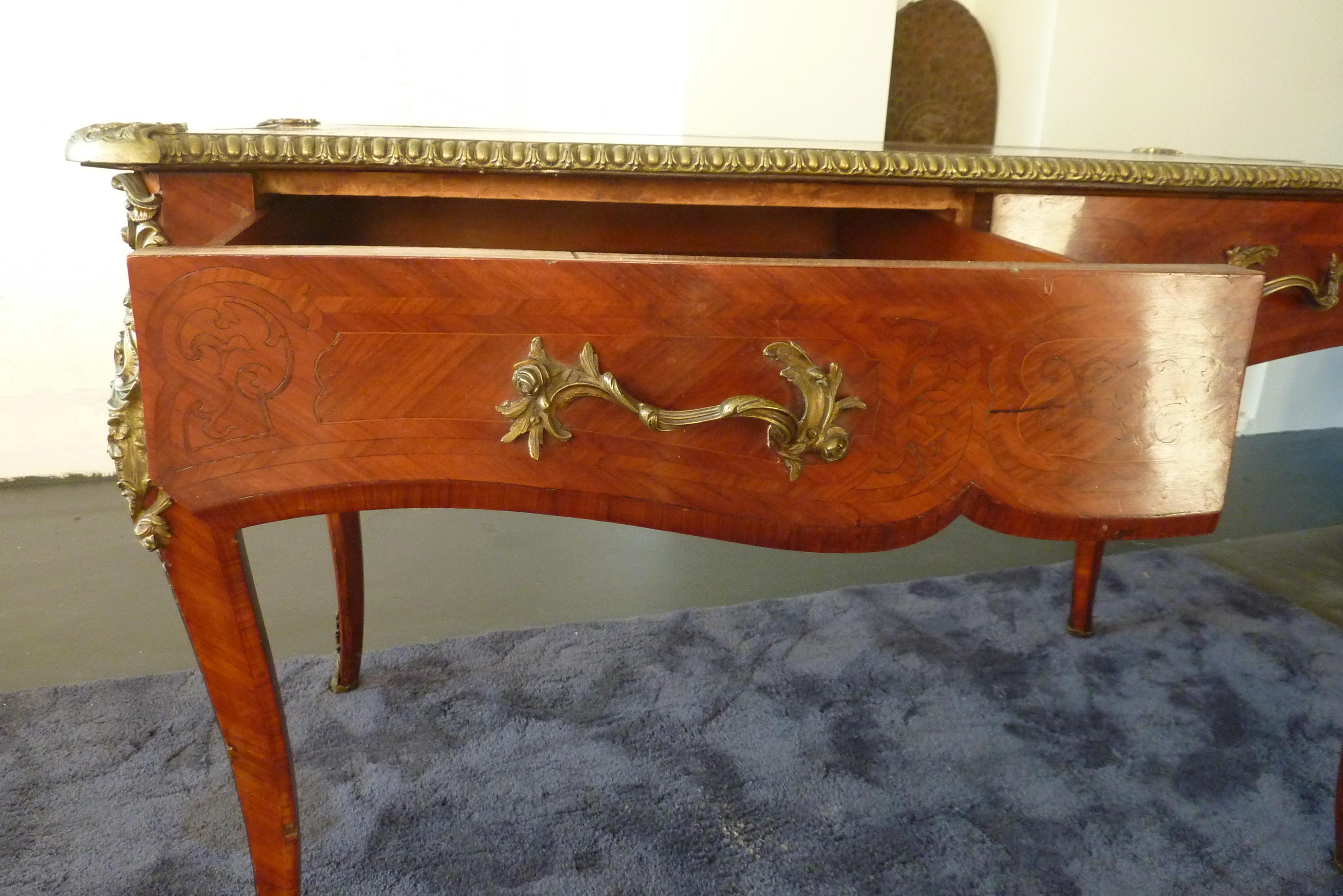 Late 19th Century Rococo Louis XV Style Flat desk By James Winter and Sons (SOHO London), United Kingdom.
Mahogany wood in Marquetry finish with Bronze Mounts in exellent quality. The desk top is provided with embossed leather.
The desk has been in