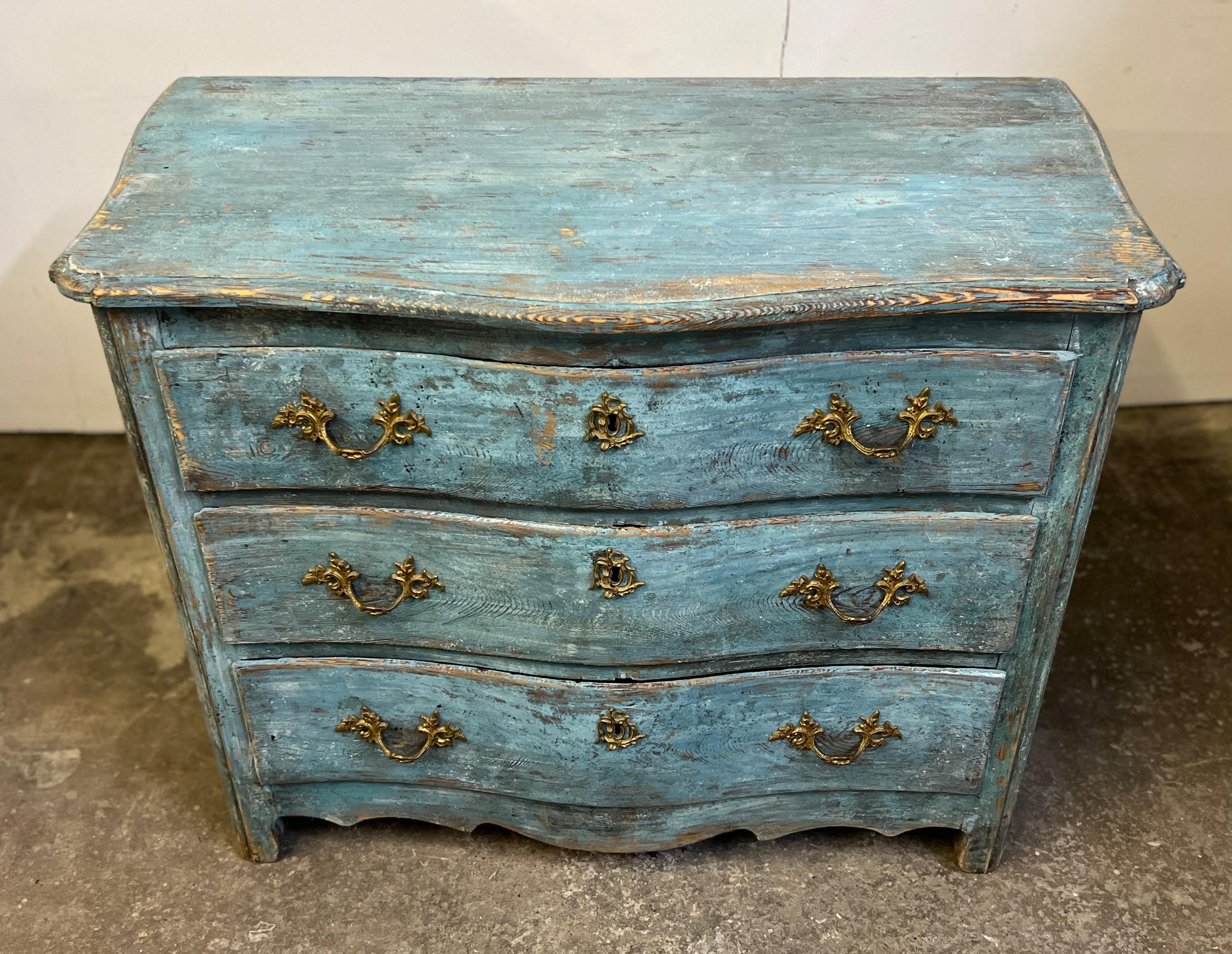 Stunning 19th century original blue painted Rococo commode. This is truly a special heirloom and investment. This piece features original hardware and 4 drawers. This is perfect for any setting whether it be a traditional design space or wabi sabi