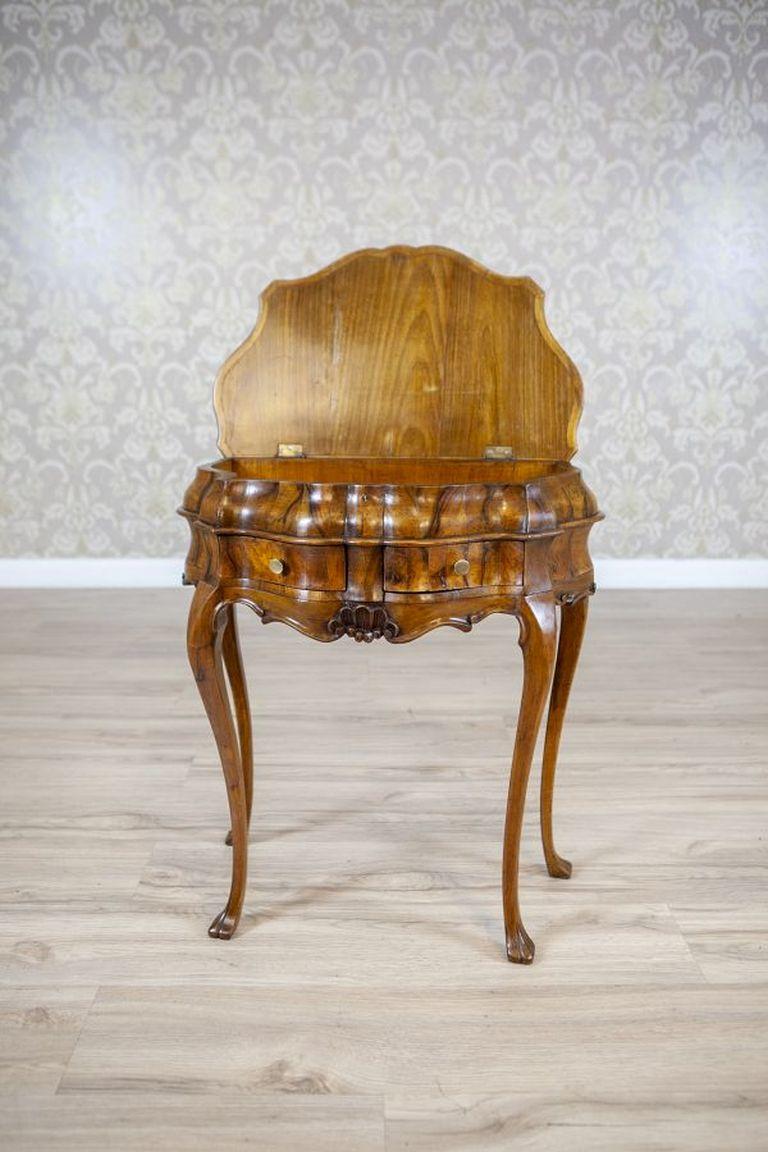 19th Century Rococo Revival Wall Console Table-Vanity in Rich Graining

Furniture in the form of a console in the Neorococo style, dating back to the 4th quarter of the 19th century. Semi-circular body with two small drawers covered by an