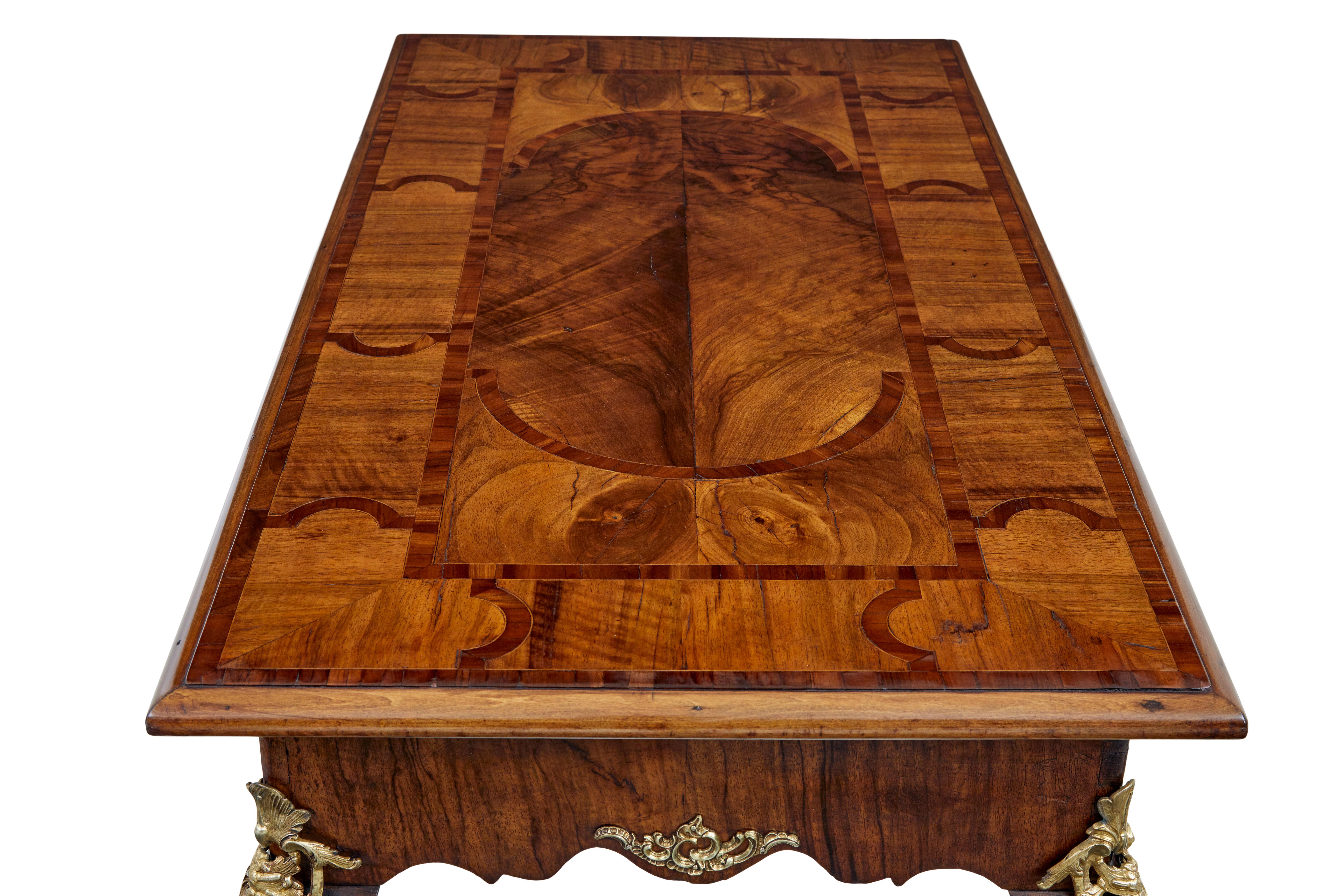 Beautiful walnut inlaid side table circa 1830.

Top surface with contrasting walnut veneers arranged into a symetrical design.  Shaped frieze with decorative ormolu mounts on each side.  Further mounts on the top of cabriole leg and to the base of