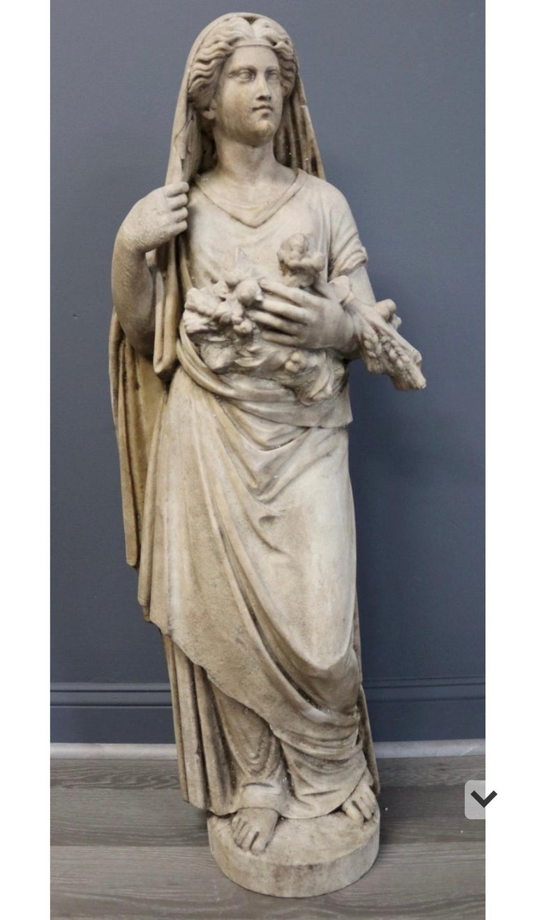 19th century or earlier carved marble statue of the Roman Goddess Fortuna, also known at Tyche. Well carved toga clad Roman female image in veil and Roman hairstyle. Holding attributes of fruits and wheat.

Condition is weather worn but carving