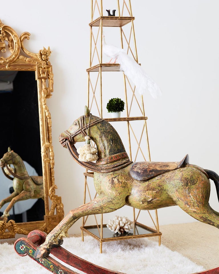 Charming 19th century Romanian hand carved wooden rocking horse. Featuring a colorful polychrome finish on a base decorated with a floral motif. Strong and stable with a beautiful distressed finish with old repairs and faded paint that add to its