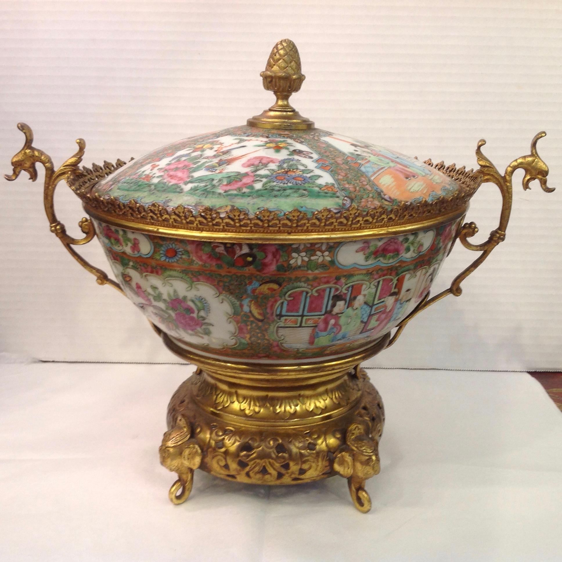 A superior bronze / brass-mounted covered bowl appointed with handles 
and an elaborate base terminating with elephant head supports 
[diameter with handles is 15