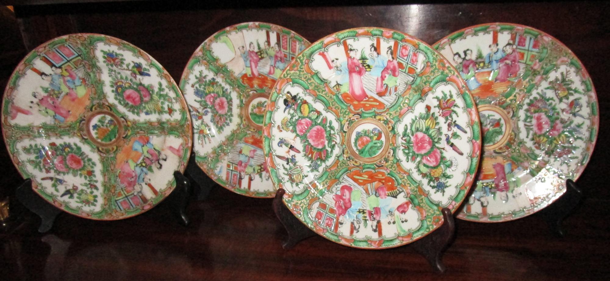 Set of four Chinese export Qing rose medallion plates featuring traditional medallion design with figures in scenes, floral and bird panels. Pink rose central medallion. Floral border.