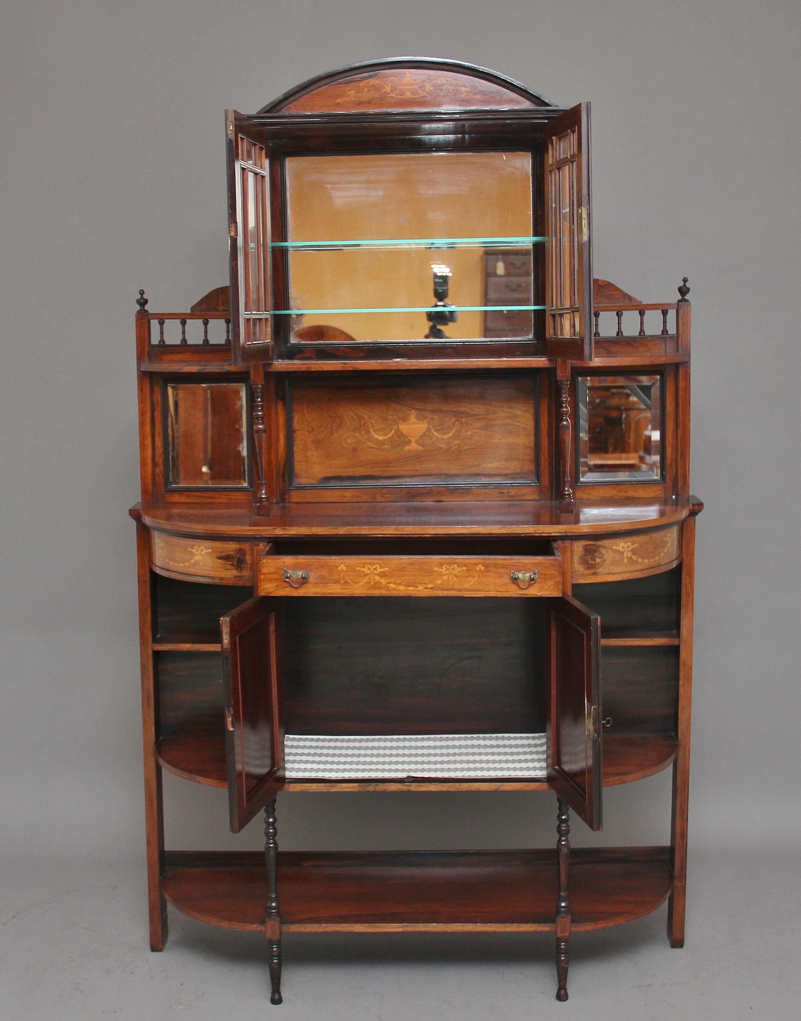 A lovely quality 19th century Sheraton revival rosewood and inlaid cabinet, consisting of an arrangement of doors, shelves and mirrors, wonderful quality inlay on the door and drawer fronts as well as the back panel, finely turned column supports,