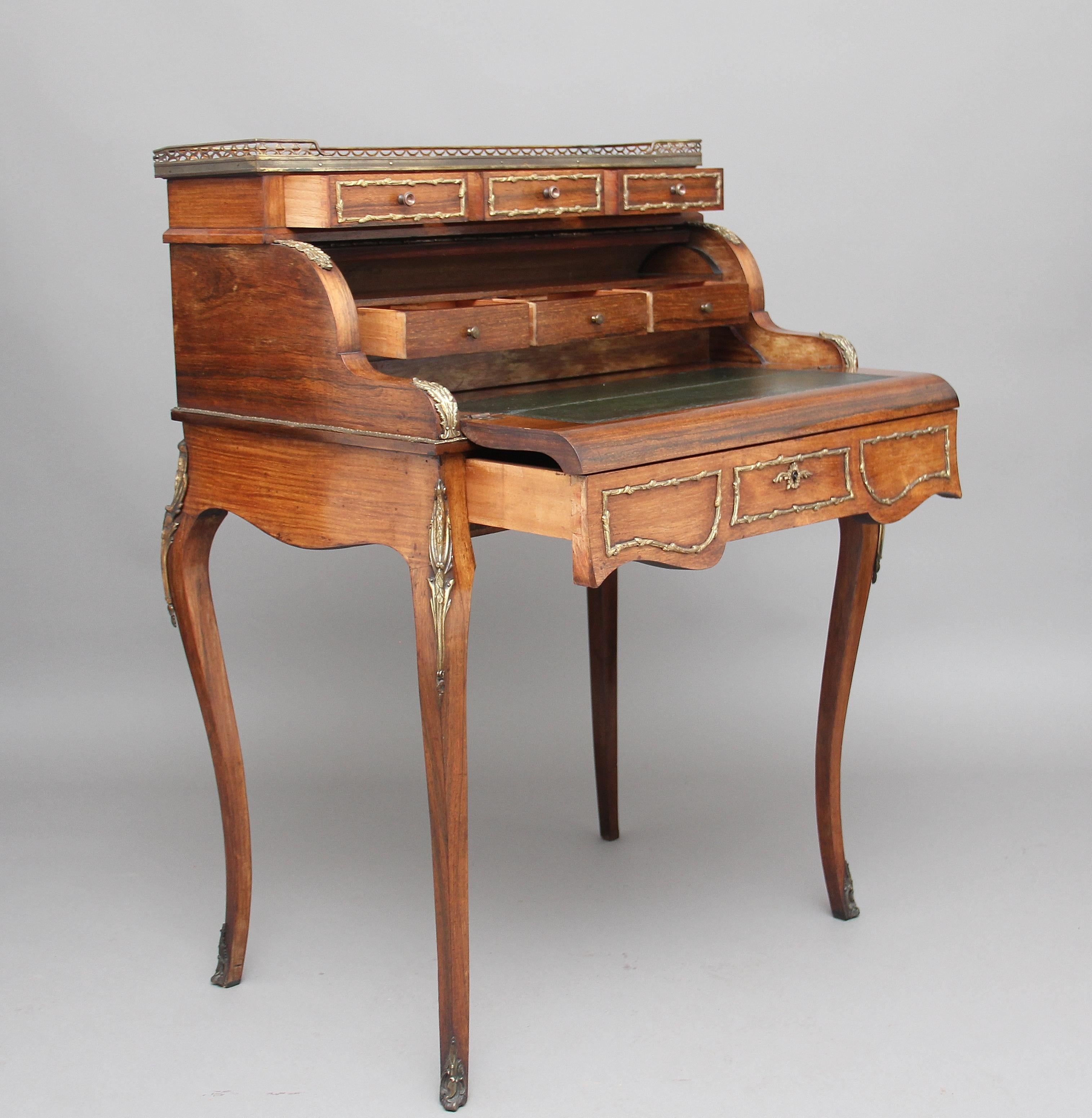 19th century French rosewood and ormolu cylinder bureau on four cabriole legs, with one long drawer which when you open it the cylinder opens and you flip the fall over which rests on the open drawer to reveal a green leather writing surface and