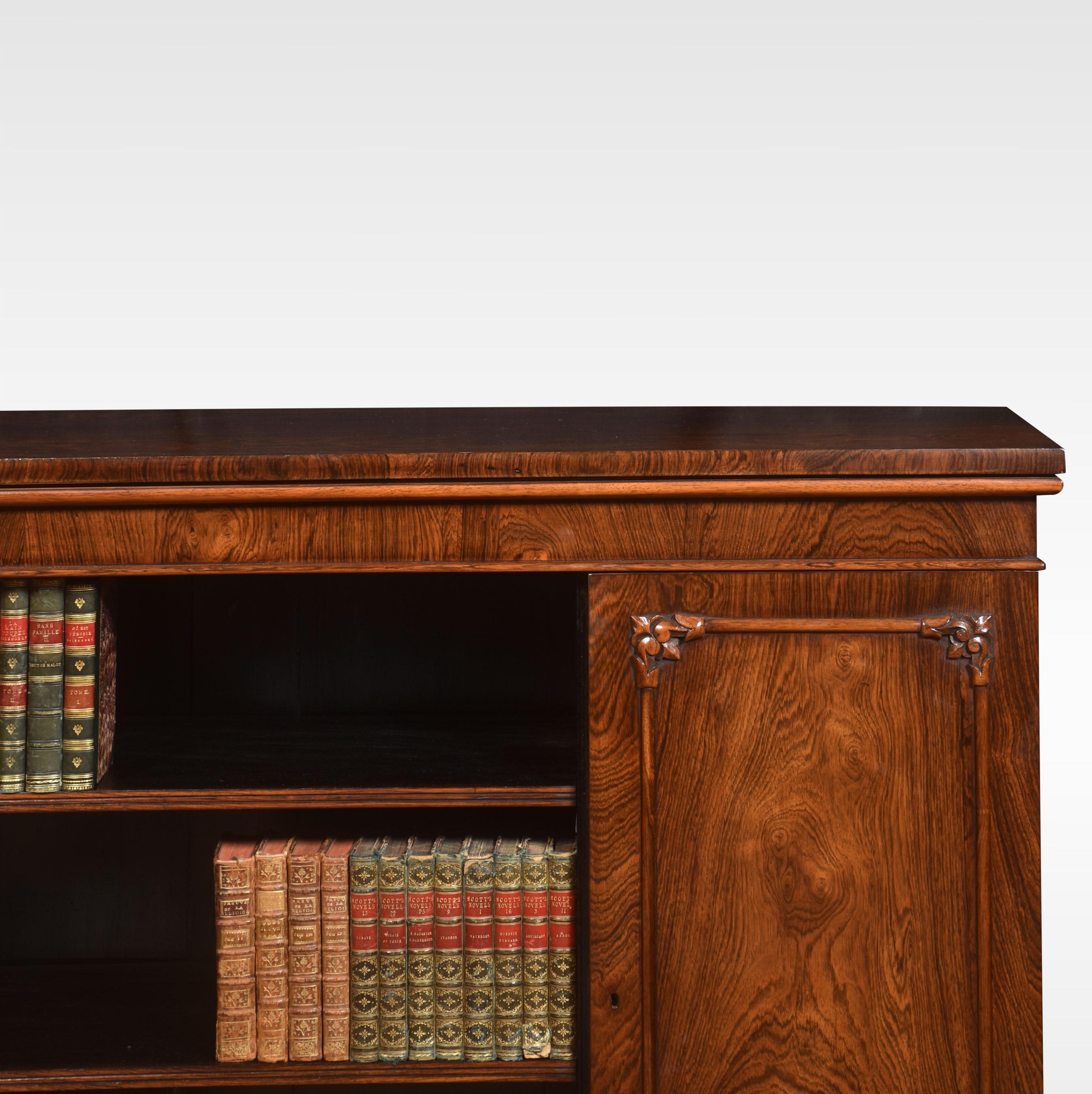 Rosewood bookcase, the large rectangular top above central open bookcase having two adjustable shelves, flanked by well figured paneled doors opening to reveal further shelving. All raised up on plinth base.
Dimensions
Height 36 Inches
Width 58