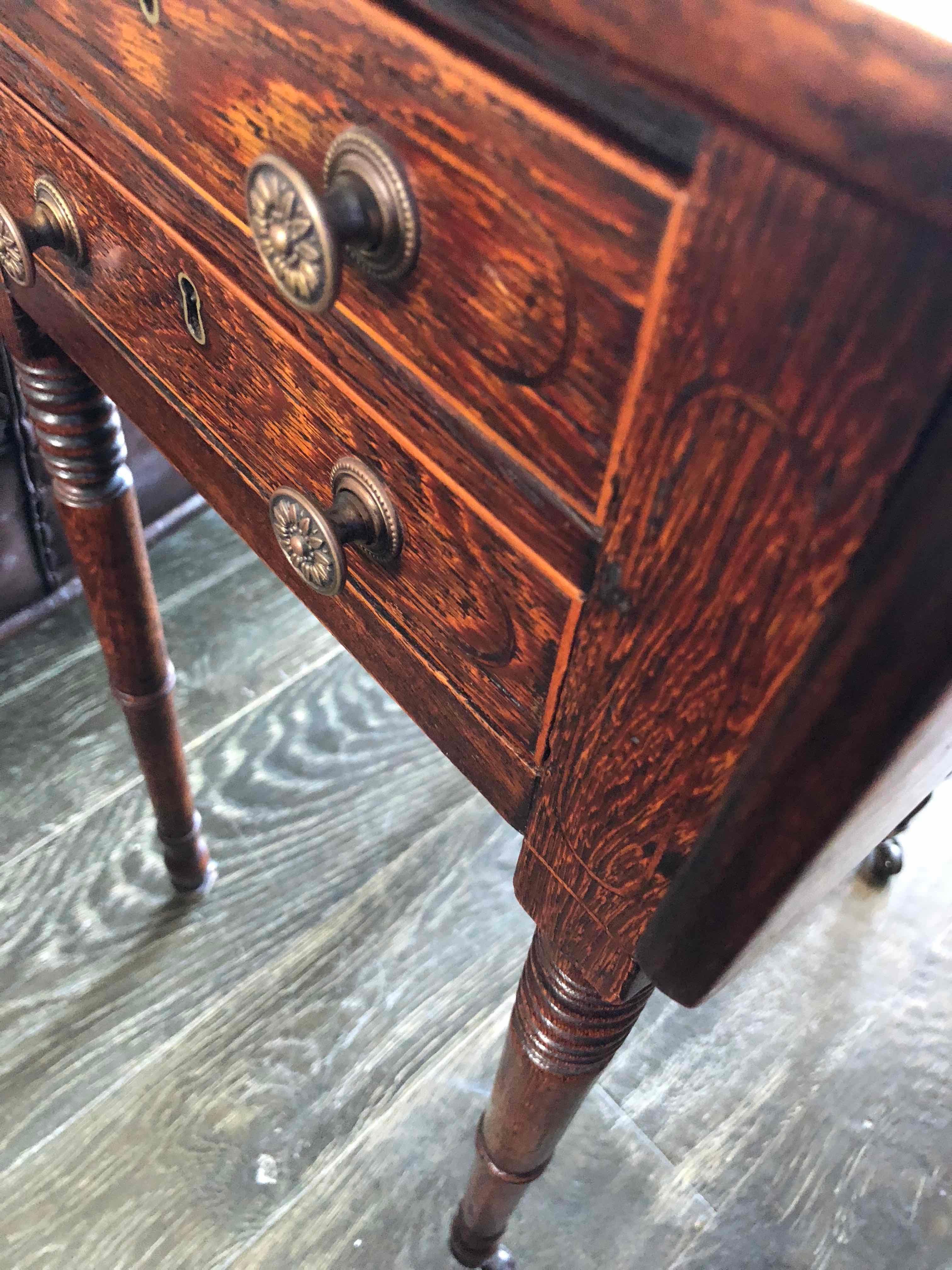 19th century rosewood drop-leaf side table with two drawers on castors.