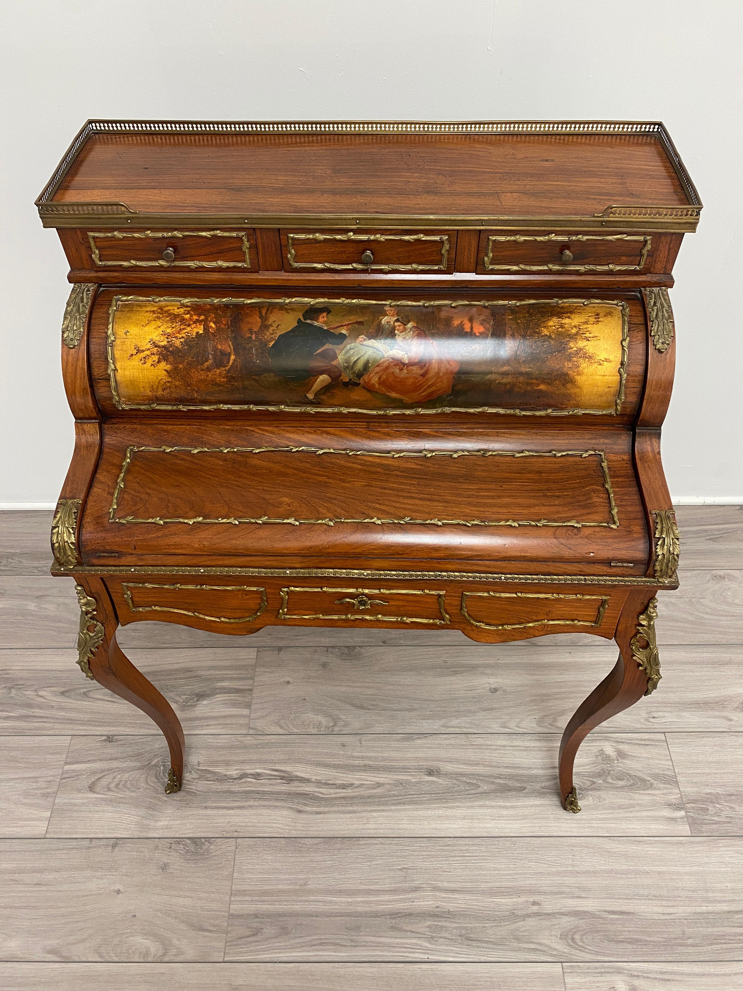 A late 19th century Louis XV style gilt bronze mounted hand painted bureau cylindre. Highly intricate bronze mounts on the writing surface and drawer front. Bronze mounts on the knees of the cabriolet legs as well as bronze sabots on the feet. The