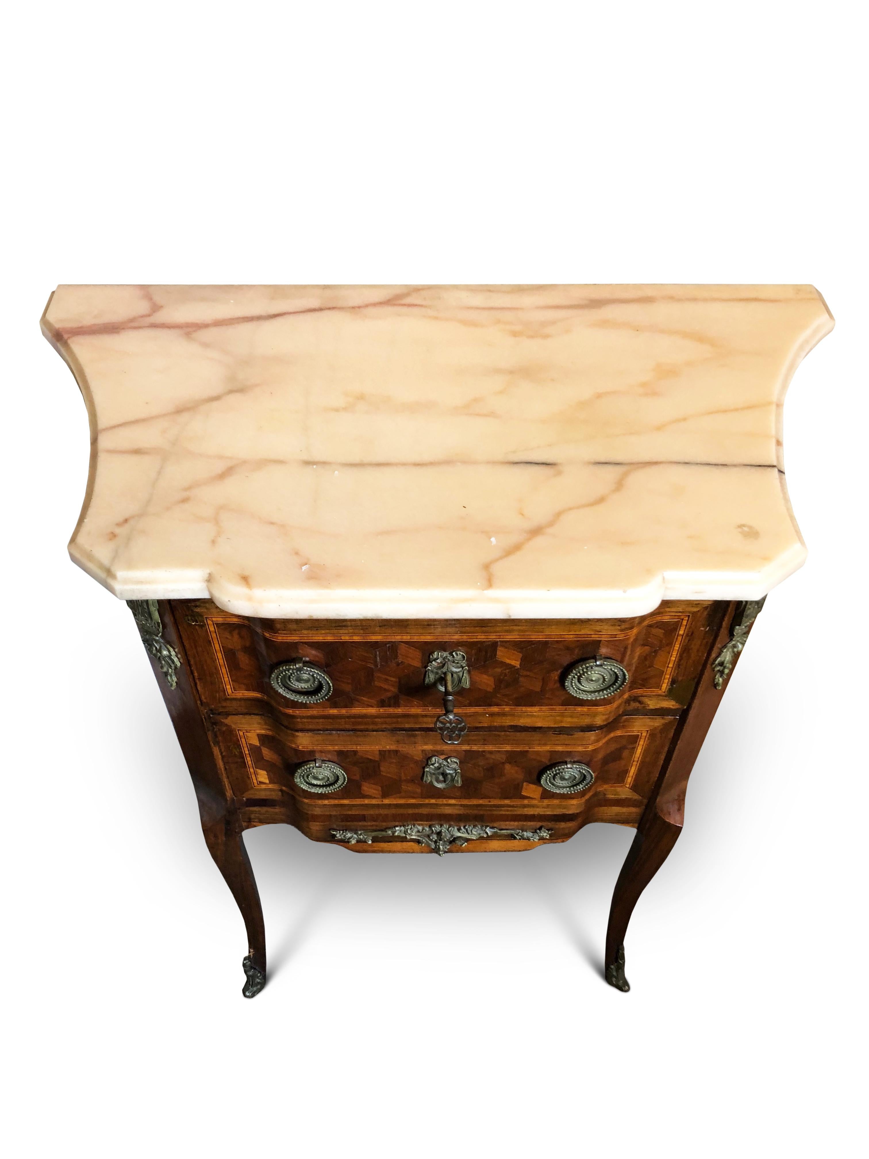 19th century rosewood French parquetry side or bedside table, circa 1860
Original marble top with two parquetry cross-banded drawers beneath flanked by brass-mounted side columns.
Slender cabriole legs with brass capped feet.