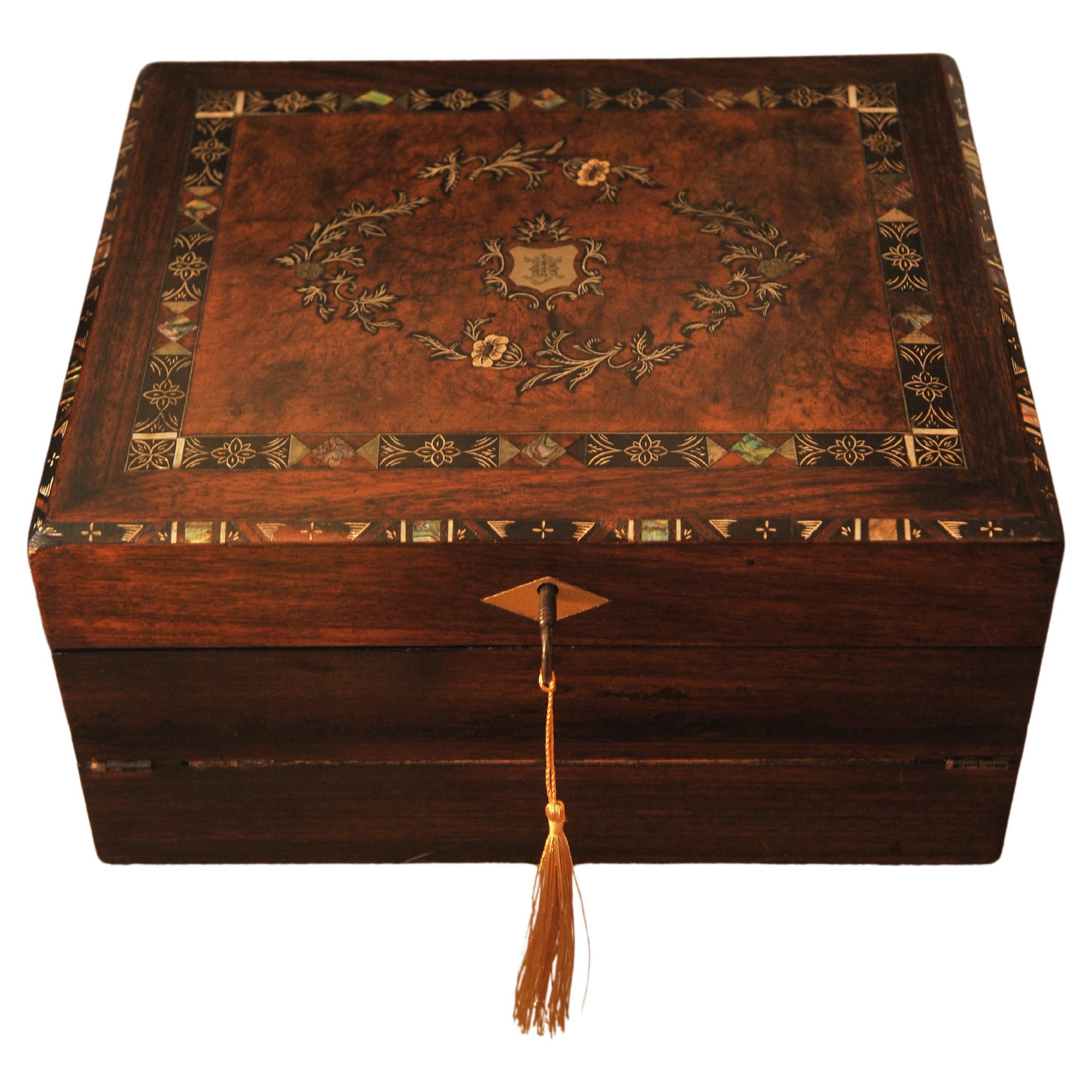 19th Century Victorian Rosewood Decorative Inlaid Writing Slope With An Engraved Shield. Stationary Compartments and Storage Space.

The item has black ebonised decorative accents & is fitted with a tooled black leather interior 

Supplied with two