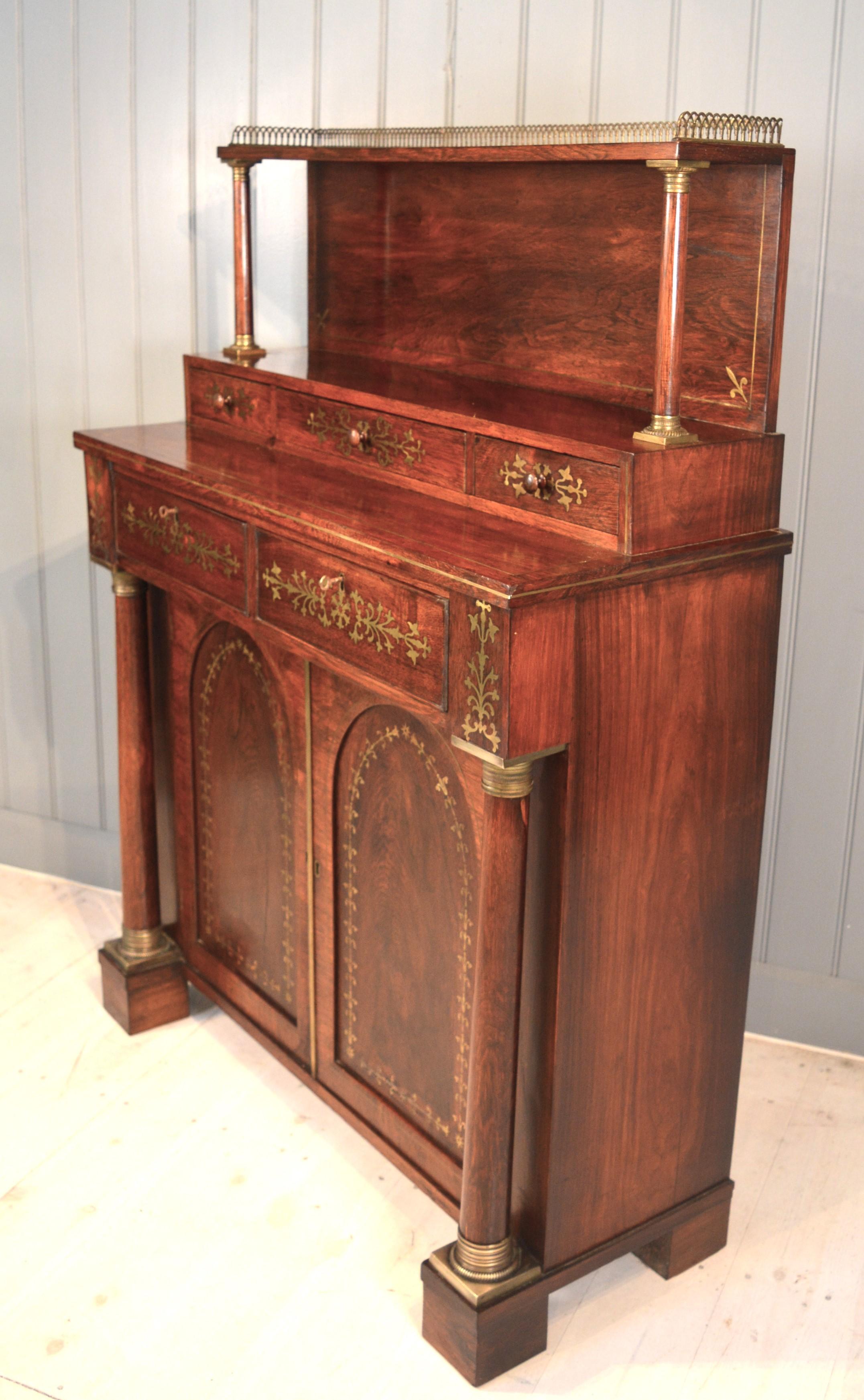 A very showy Regency side cabinet or chiffonier in Brazilian rosewood. English circa 1820 of very good quality having mahogany drawer linings even mahogany backboards. The veneers are chased with finely cut brass inlay decorating the entire front.