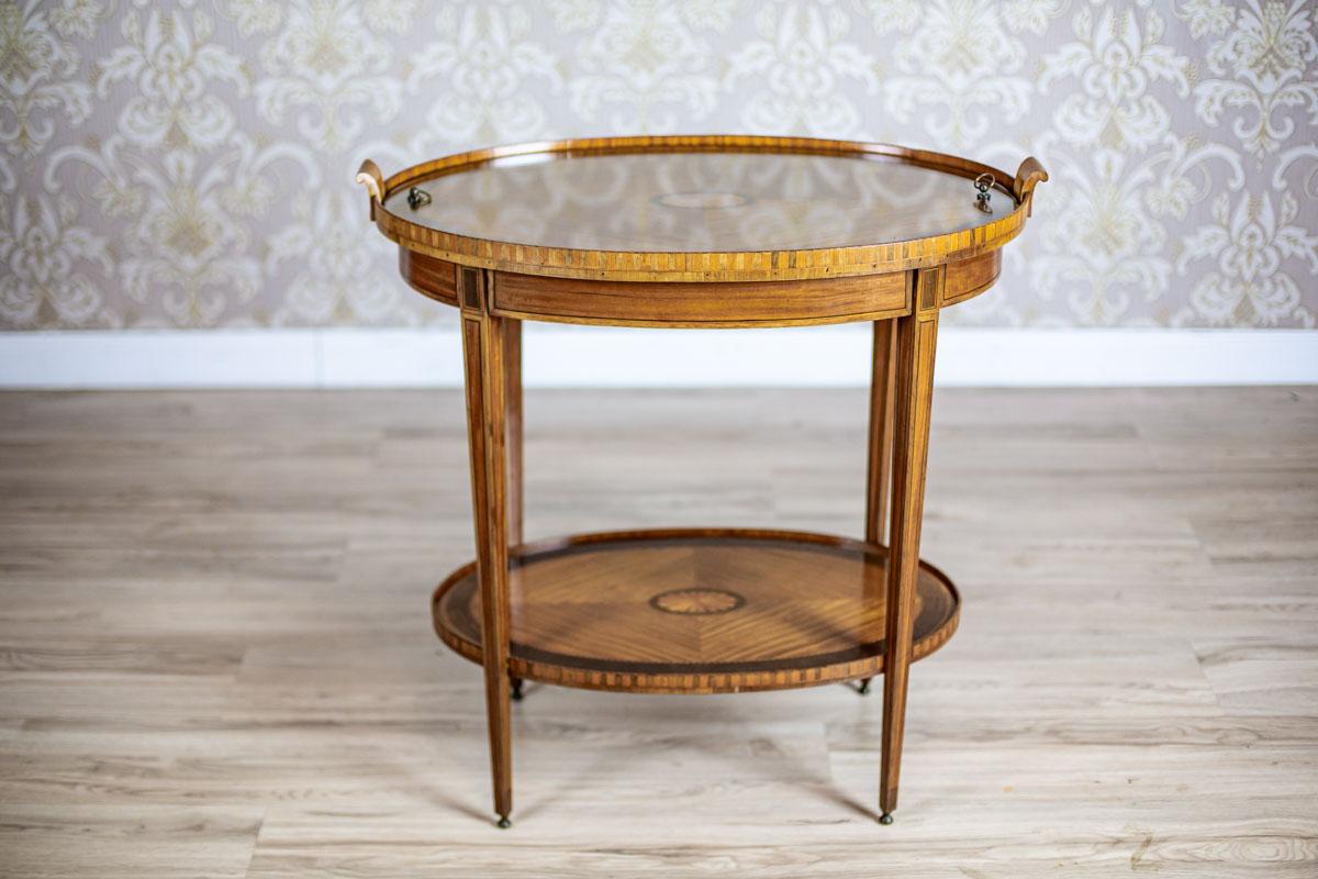 19th Century Late Victorian English Rosewood Tea Table in Brown

We present you a table covered with rosewood veneer. It is from fourth quarter of the 19th century.
The oval top is supported on thin legs, which are connected at the bottom with a