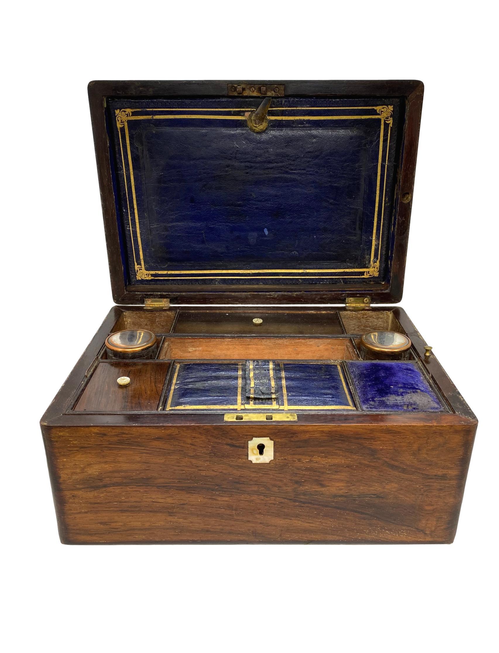 Rosewood writing box with writing slope and hand-tooled leather, with mother-of-pearl inlay, the fitted interior with blue velvet lining and storage compartments. Completely original, English, ca. 1870 

  