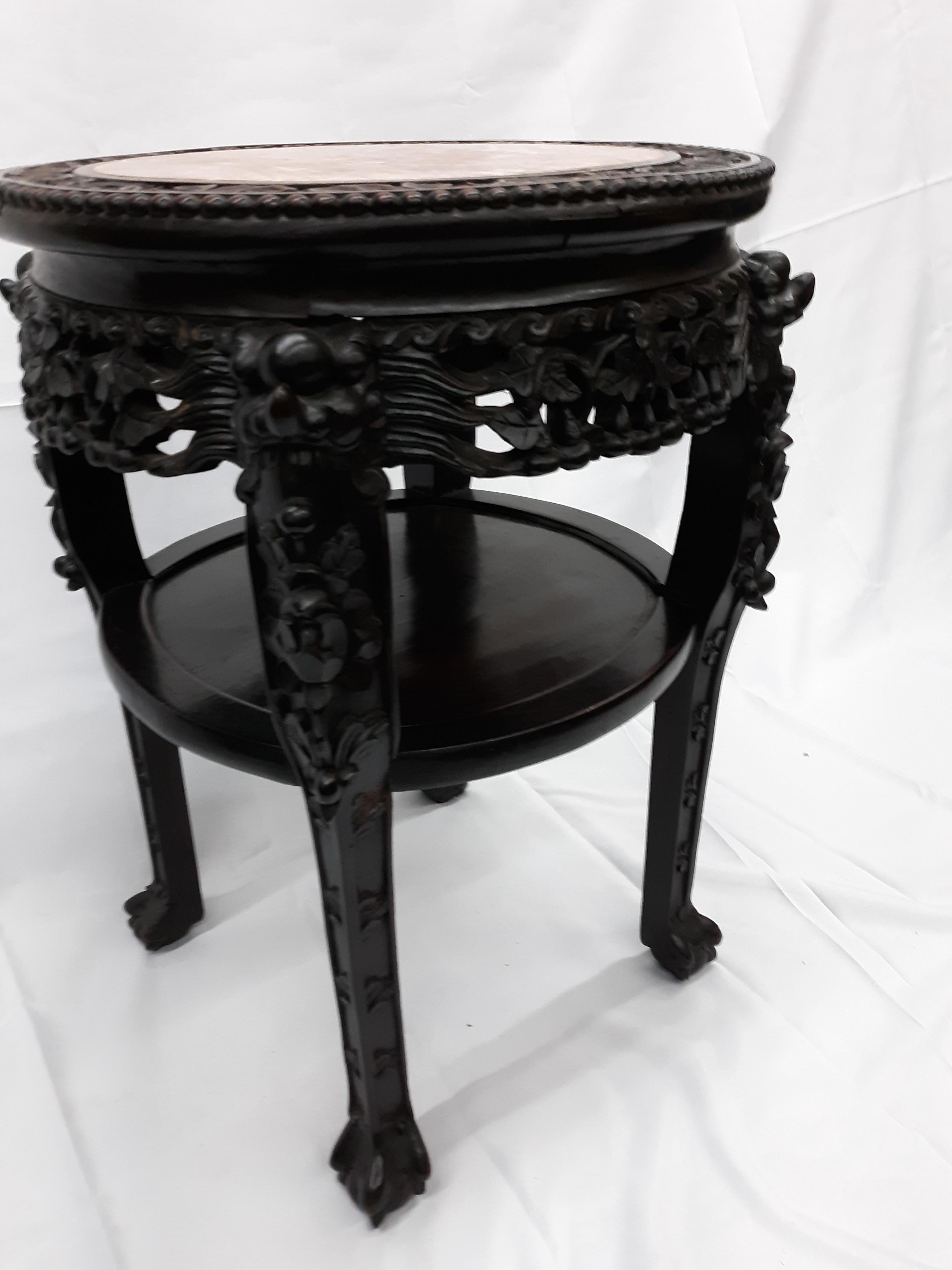 A 19th century antique Chinese heavily carved hardwood stand table with rouge marble top insert, the inset marble top over carved hardwood apron, unique 4 legs, see more pictures. May be purchased along with matching tables of same look, and large