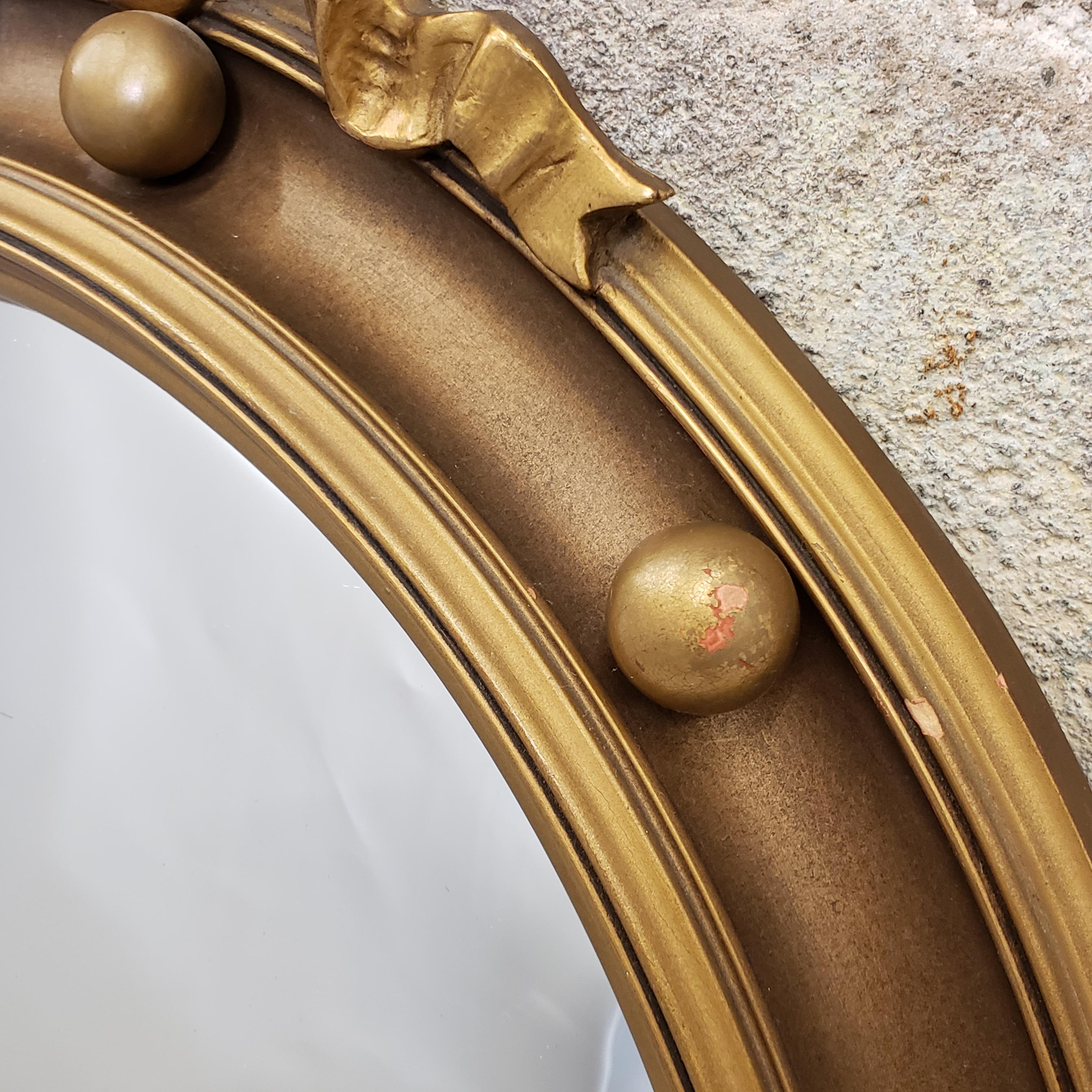 round gold mirror with balls