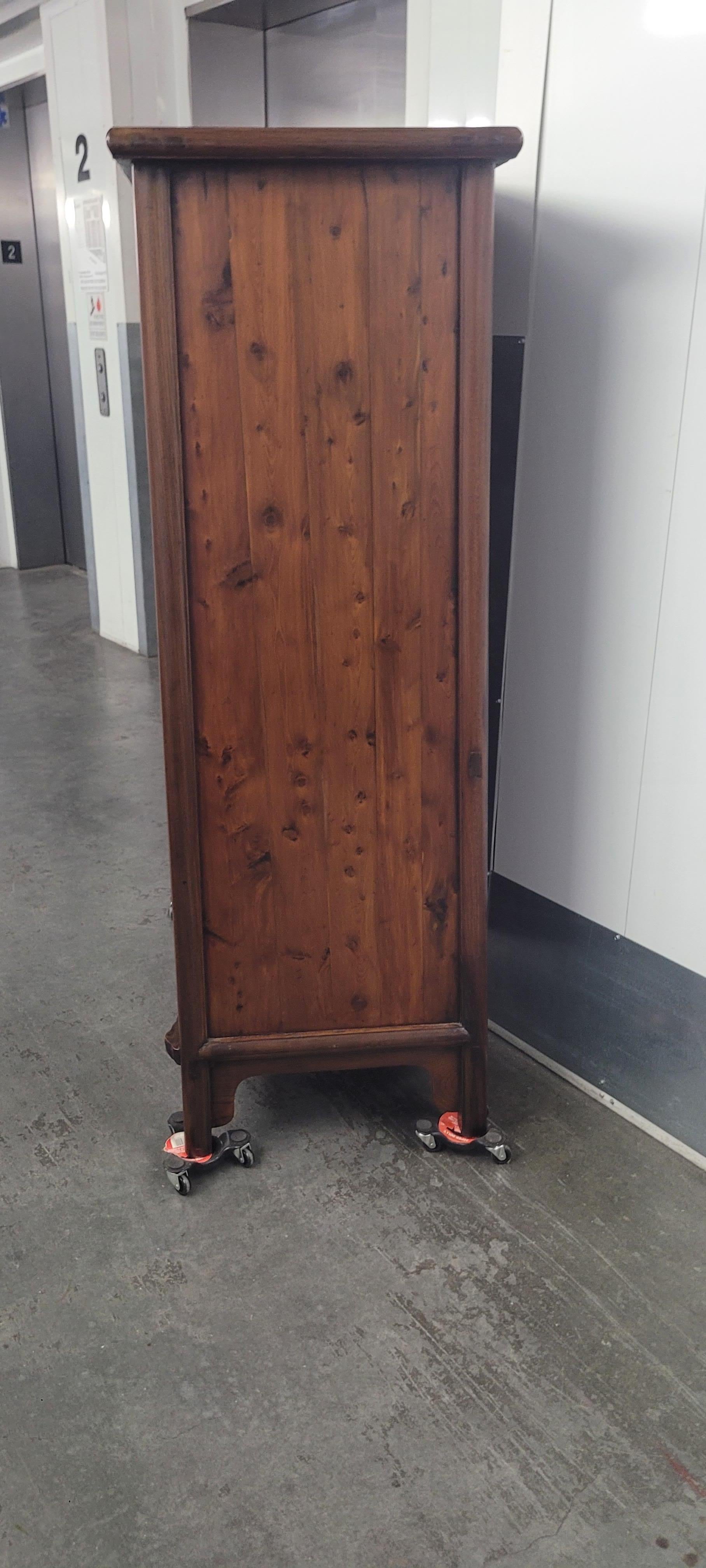 Tapered Cabinet	 35.75w x 18.75d x 56h

This round corner tapered cabinet has a top which hangs slightly over the body frame.  All the floating panels are made of one piece of wood. The cabinet has a very nice proportion.  The apron is simple and
