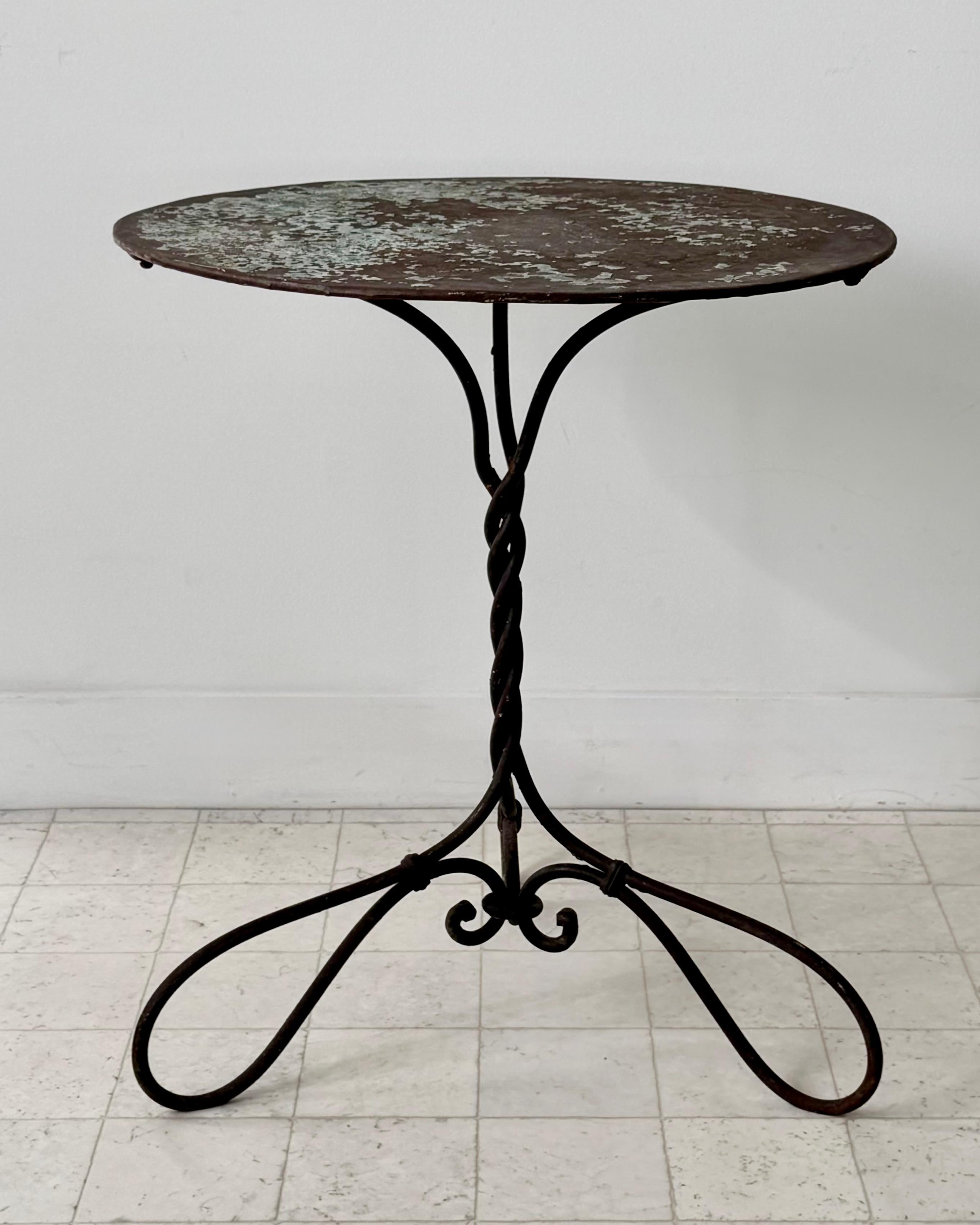 A charming antique 19th century French garden table with twisted wrought iron base and rustic patinated metal top.
Unique and timeless design for use as garden setting or addind a rustic charm  to a living room or sunroom.
