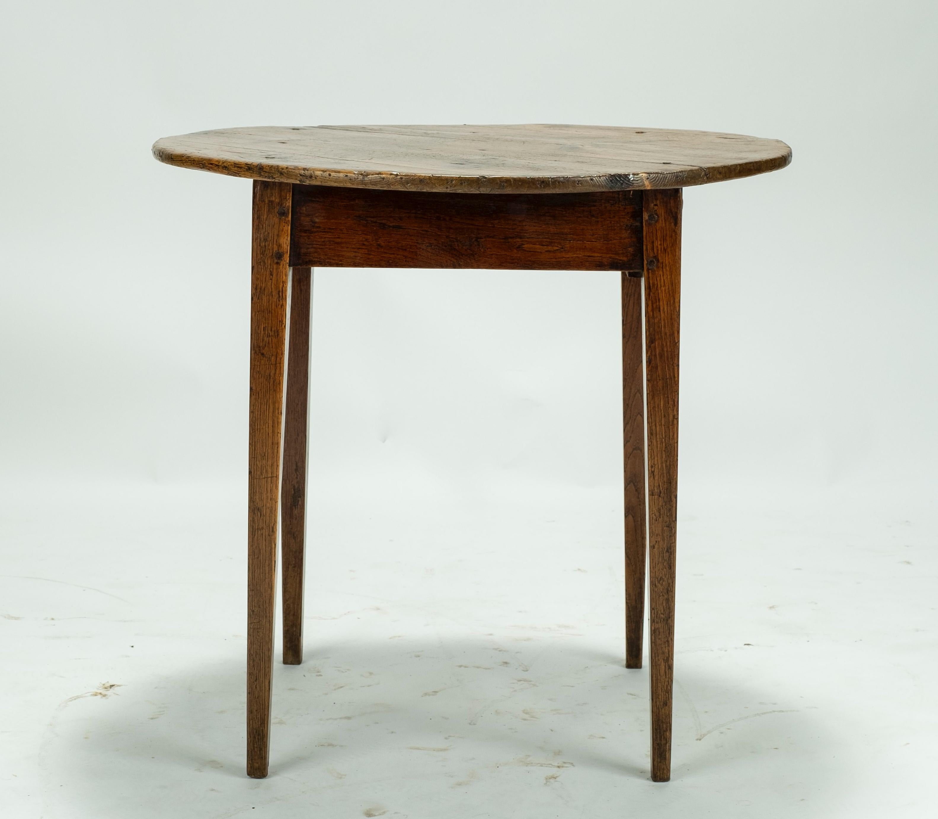 19th century pine round table on four legs with a small drawer.