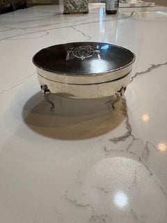 19th century round tortoise shell box with silver plate surround and feet.