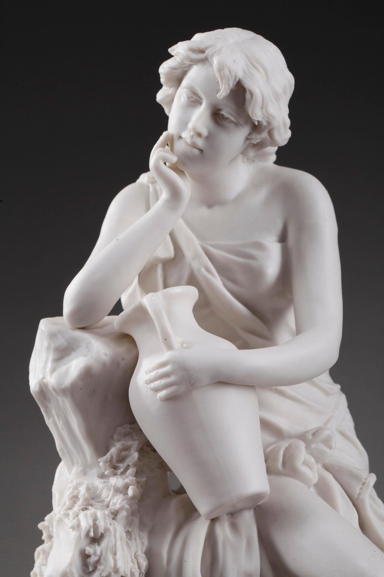 Art Nouveau Royal Dux biscuit depicting a dreamy woman sitting on a rock highlighted with plants. She wears a fluid dress that discovers her shoulder and thighs, and holds an Amphora with one hand. The biscuit is stamped with Royal Dux Bohemia