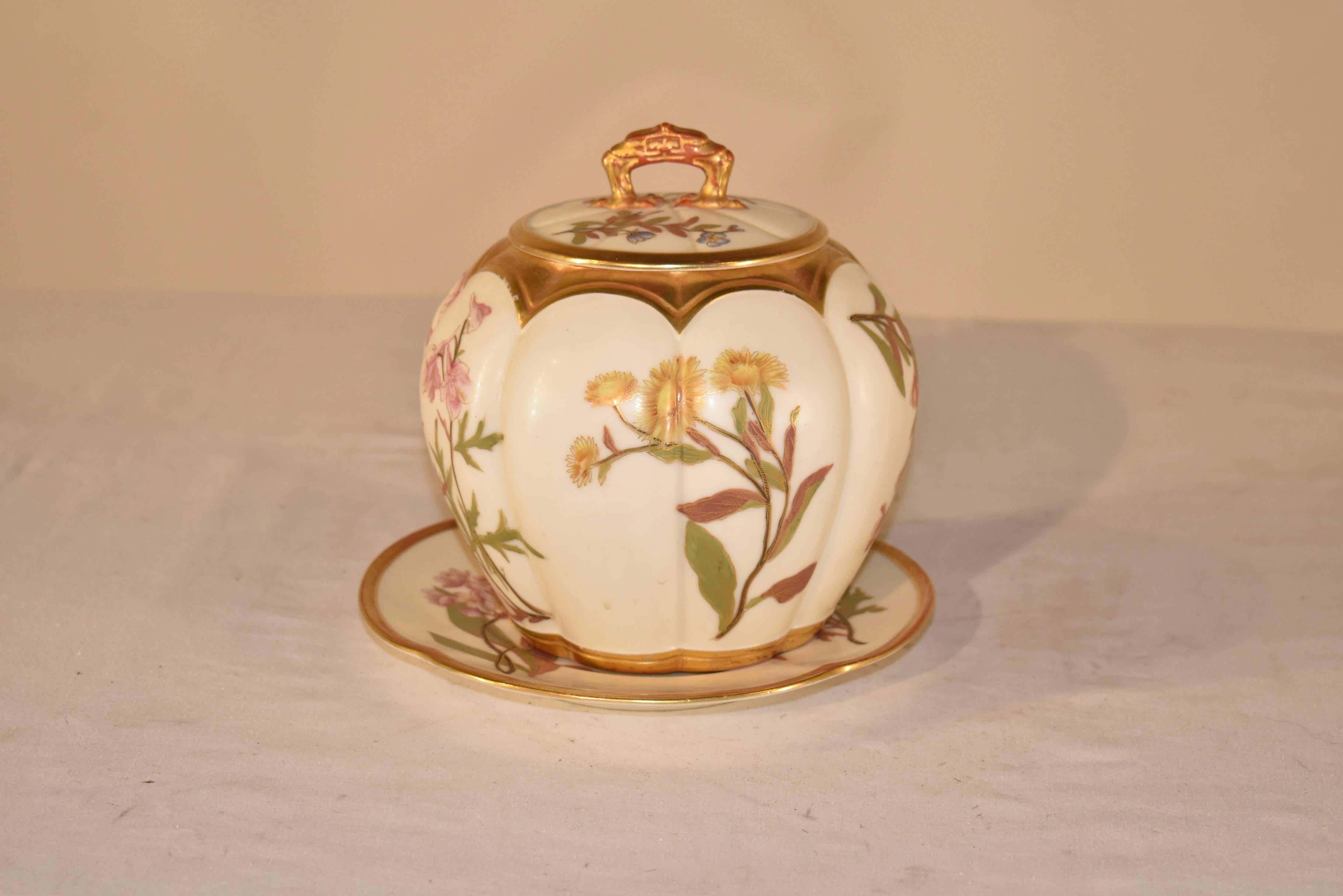 A gorgeous Victorian Royal Worcester melon shaped biscuit box featuring a gorgeous floral design embellished with gilt detailing. The rim of the jar is embellished with bats wing fluting and the gilt accents carry though from the finial on the lid