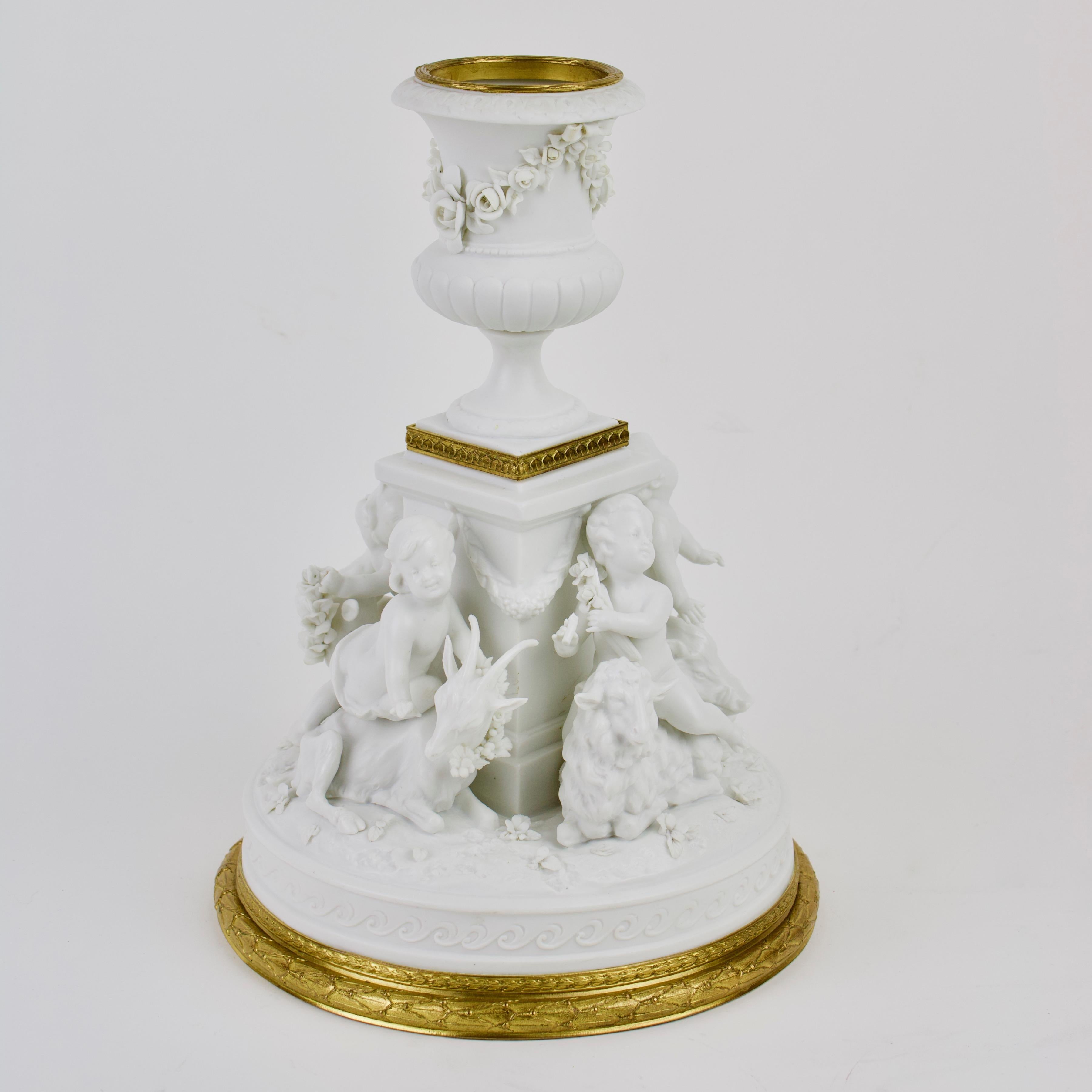 German/Rudolstadt-Volkstedt late 19th century figure group of putti made of biscuit porcelain: 

Four putti on landscape round pedestal around a vase pedestal, in moving posture and different states of mind playing with a goat, a sheep, a boar and
