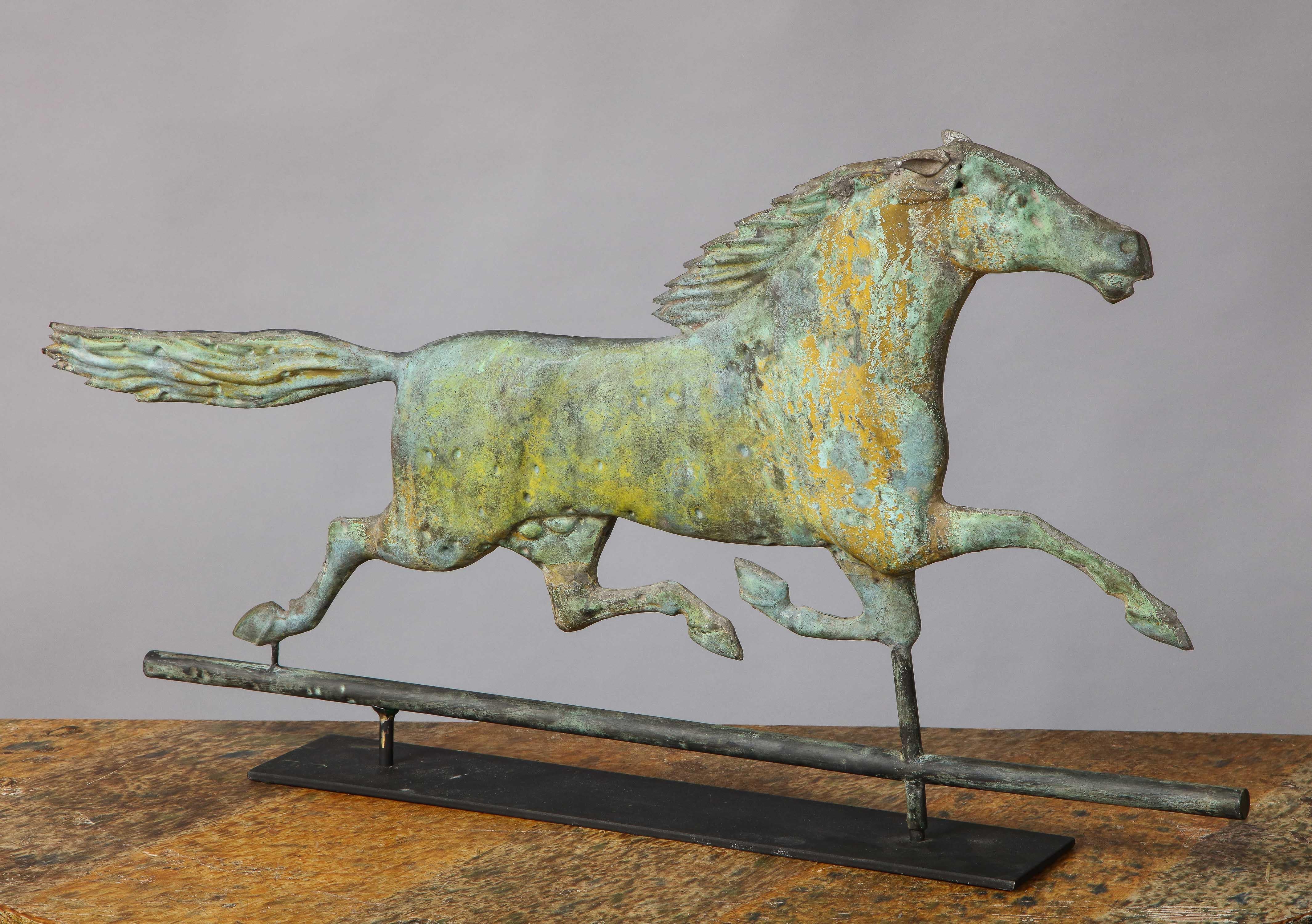 Fine American 19th century running horse weathervane, the full bodied copper horse having richly patinated surface with traces of original mustard paint (or yellow gold sizing).