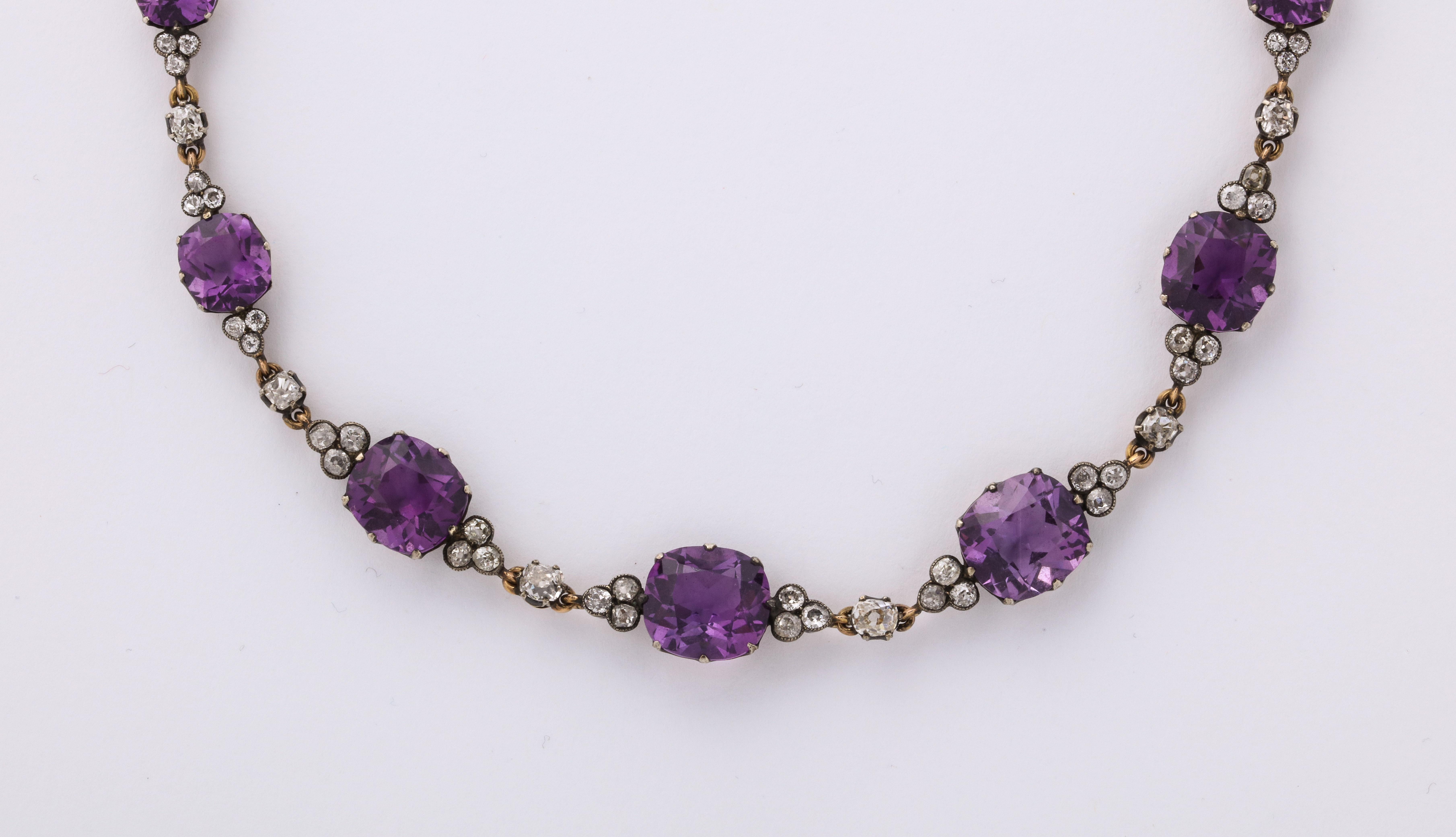 The necklace is set with 13 amethysts and approximately 4 carats of old mine cut diamonds. Hallmarked with Russian assay and maker's mark. Clasp is a long oval amethyst. c.1890