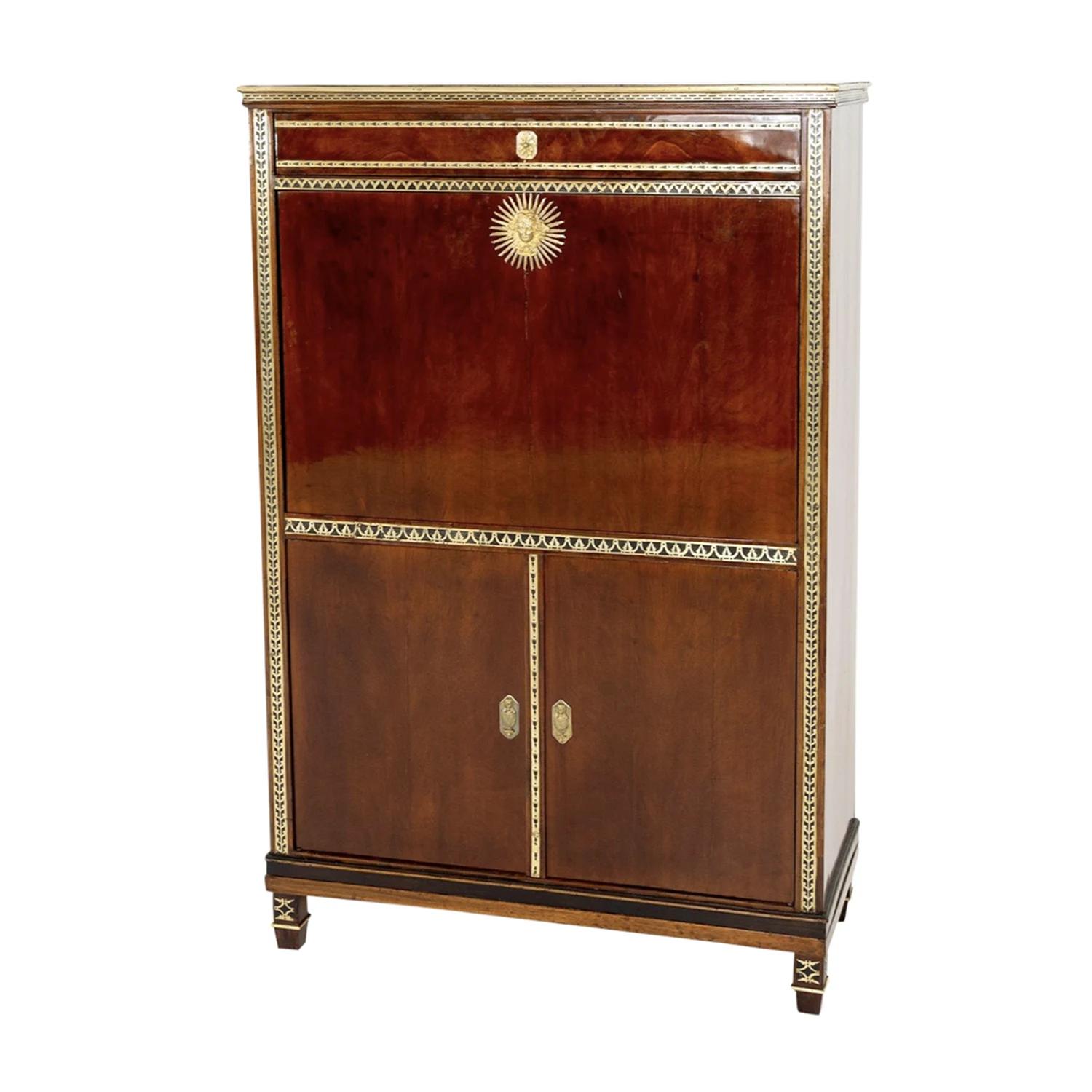 An antique Russian secretary with a writing flap made of hand crafted shellac polished, partly veneered Mahogany, designed and produced by Heinrich Gambs in good condition. The bottom part of the detailed cabinet is composed with two doors,