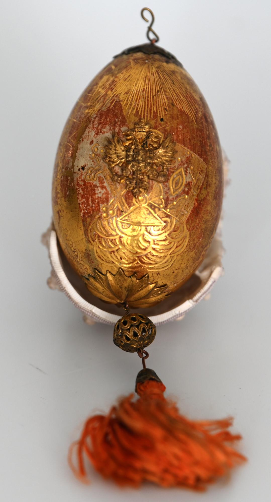 19th century Russian egg gold painted plaster with Russian double eagle 

The beautiful and charming plaster egg is gold painted. It has been made in the end of the 19th century.