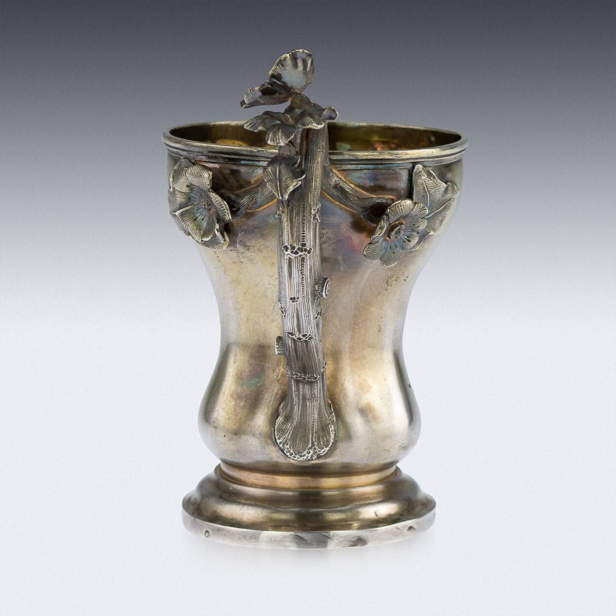 Antique mid-19th century Russian solid silver-gilt cup, of inverted pair shape, decorated with large scrolled shields with a vacant catrouche, the handle realistically modelled as a vine branch, applied with leaves and flowers, standing on a wide