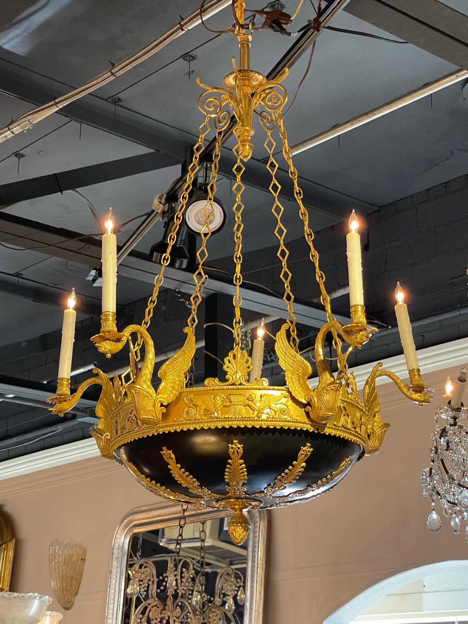 Exceptional 19th century Russian Empire style gilt bronze chandelier with 5 arms. The details on this piece are very special. Lovely finial and decorative pattern at the bottom of the chandelier. And the arms are in the shape of a swans. Very fine