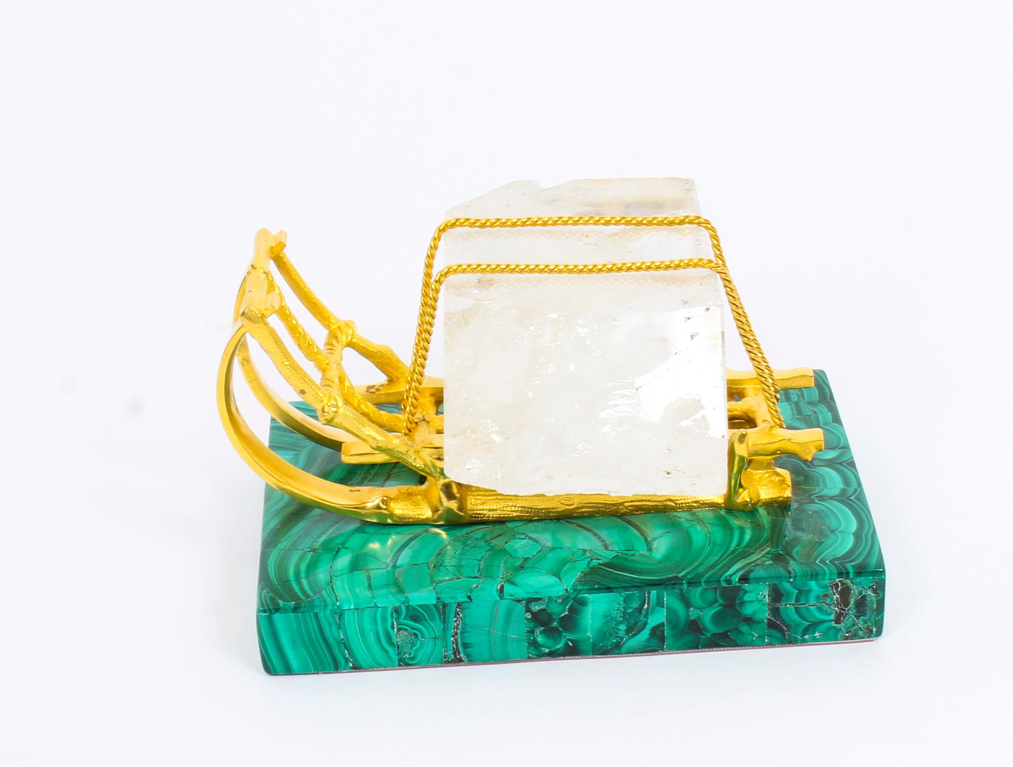 This is a truly magnificent and rare antique Russian gilt bronze, malachite and rock crystal desk stand, circa 1870 in date.

This exceptionally executed desk stand is in the novelty form of a winter sleigh carrying a prestigious rectangular block