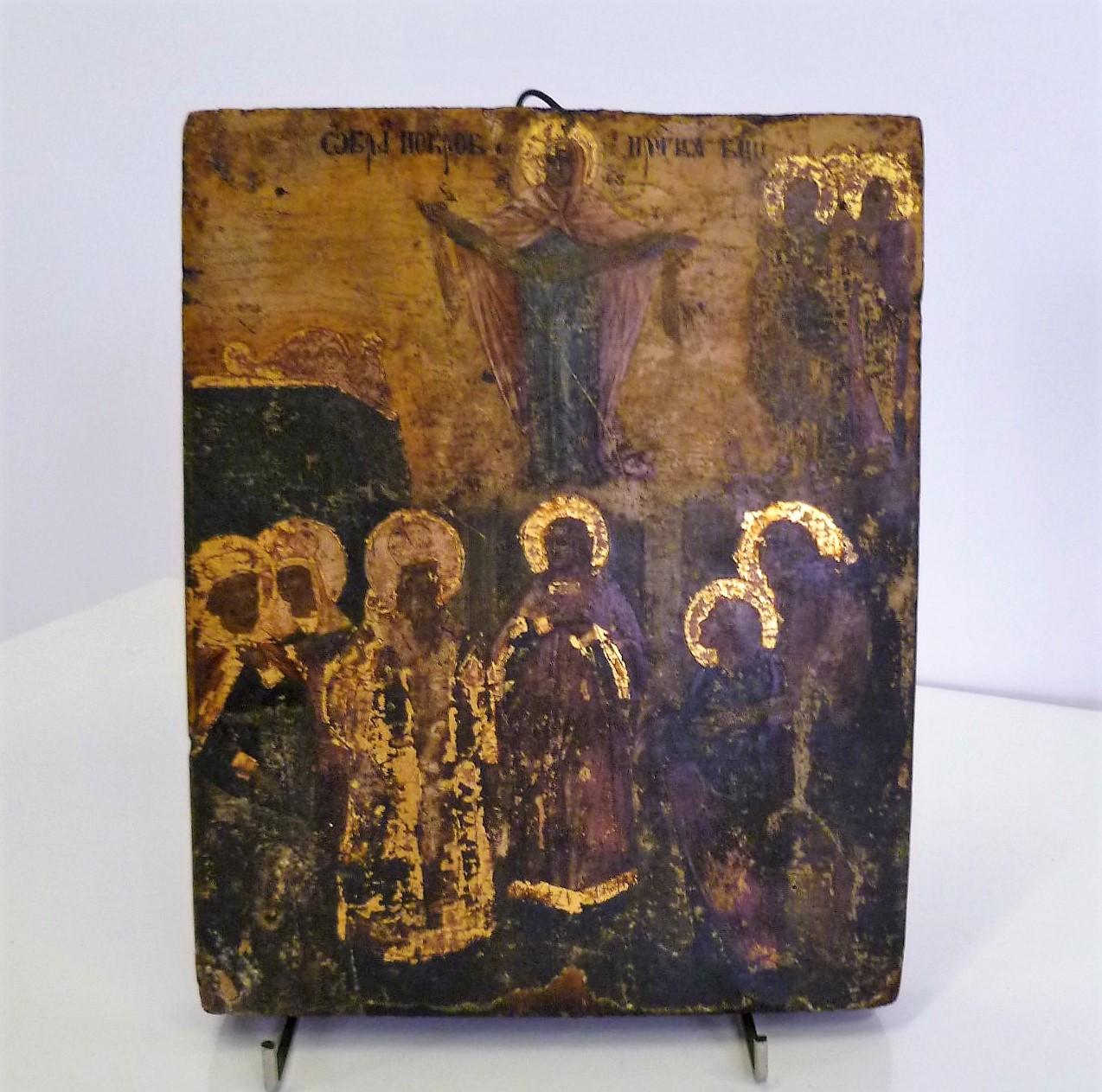 This 19th century Russian icon is representing The Protection of the Mother of God (Theotokos). Where Theokotos is spreading her veil over gathered Saints and disciples, with Andrew the Fool in the center. On the upper right there are also two