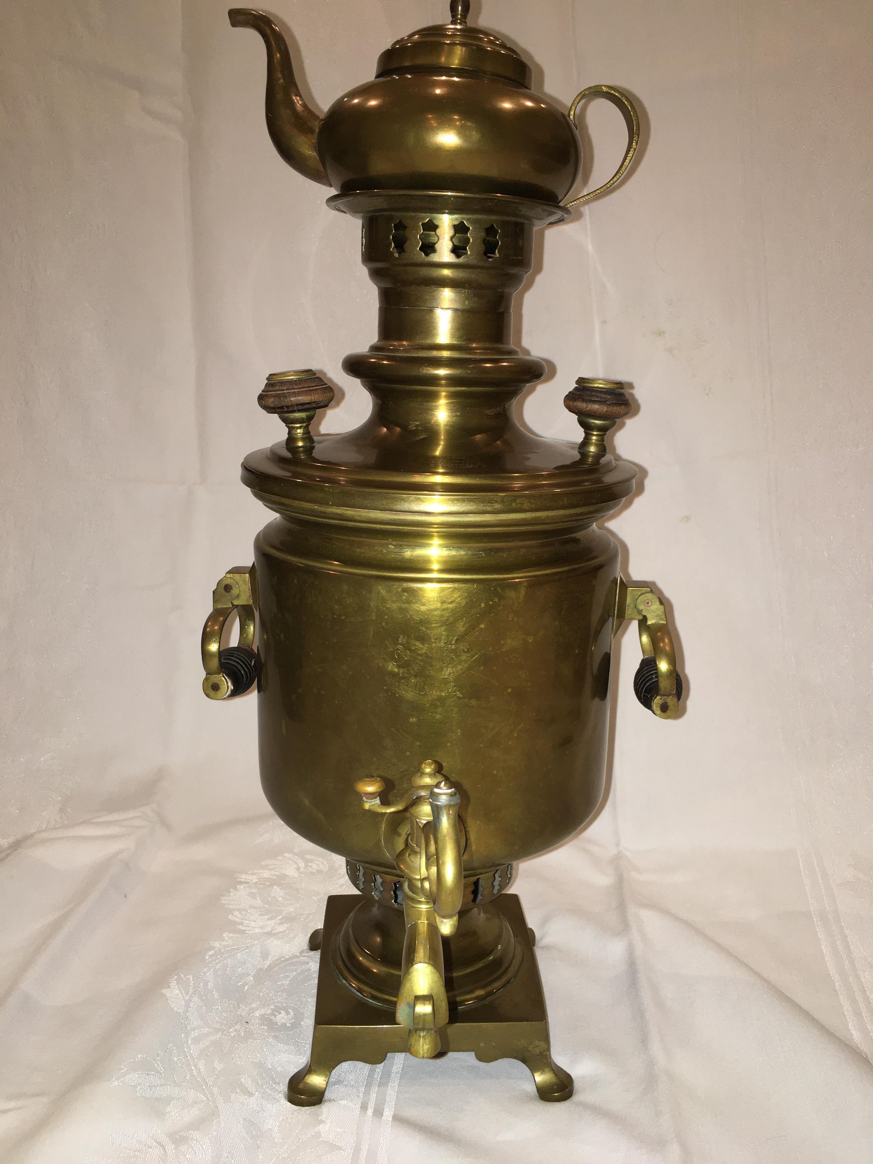 Antique brass and wood Imperial Russian Samovar. Markings stamped on the top above the spout show it was made by the Balashev Factory in Tula, Russia. Hand engraving on the side says “F (factory) B (Balashev), Tula. 

The Samovar consists of a