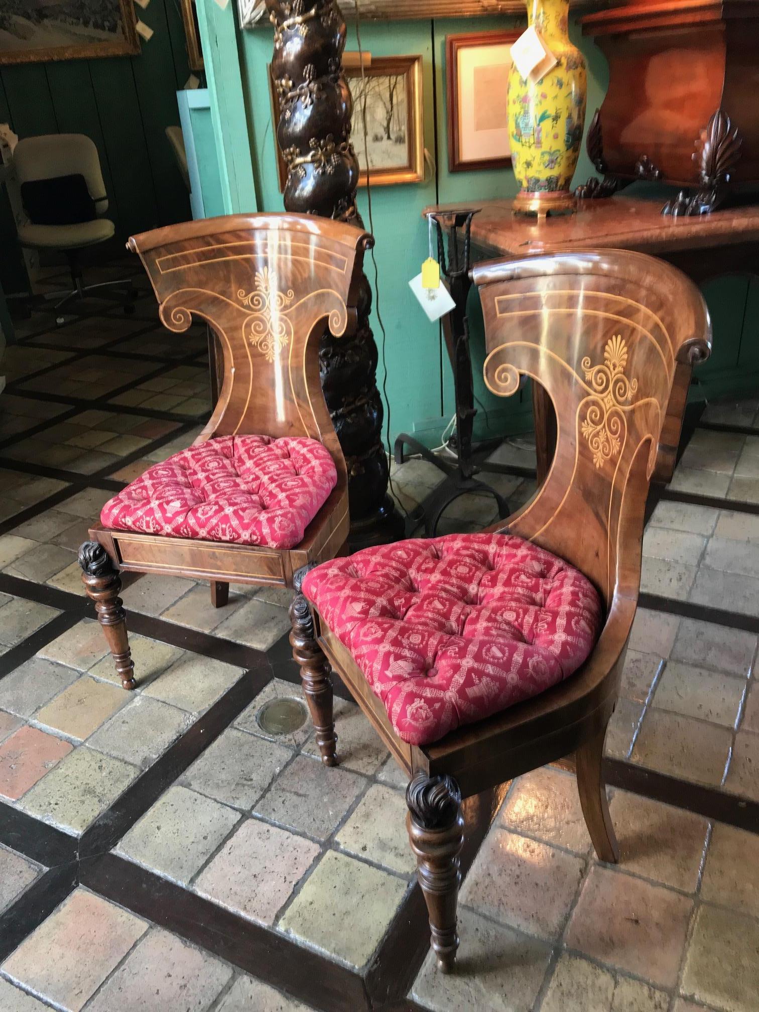 Two pairs available of 19th century neoclassic Russian officer chairs Inlaid burl mahogany, with a nicely curved barrel back, tufted red color upholstered seats , back splayed legs and beautifully carved front legs in the shape of a flame Flambeau .