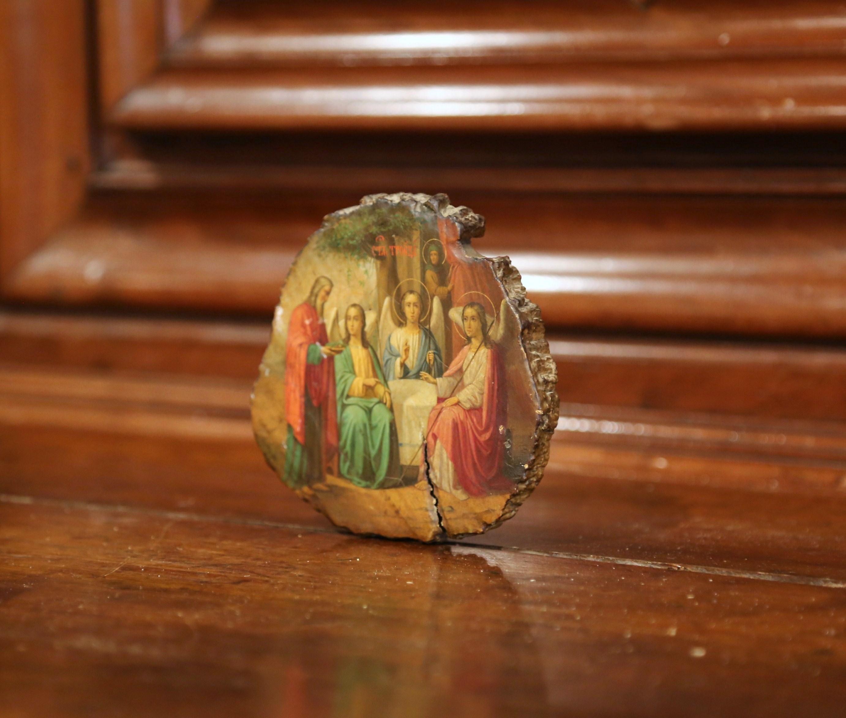 This small, antique icon was found in France, and was crafted in Russia, circa 1860. The religious art work features Abraham, the Father, and the three angels visiting him (Genesis 18: 1-15). The round, hand painted scene is in excellent condition