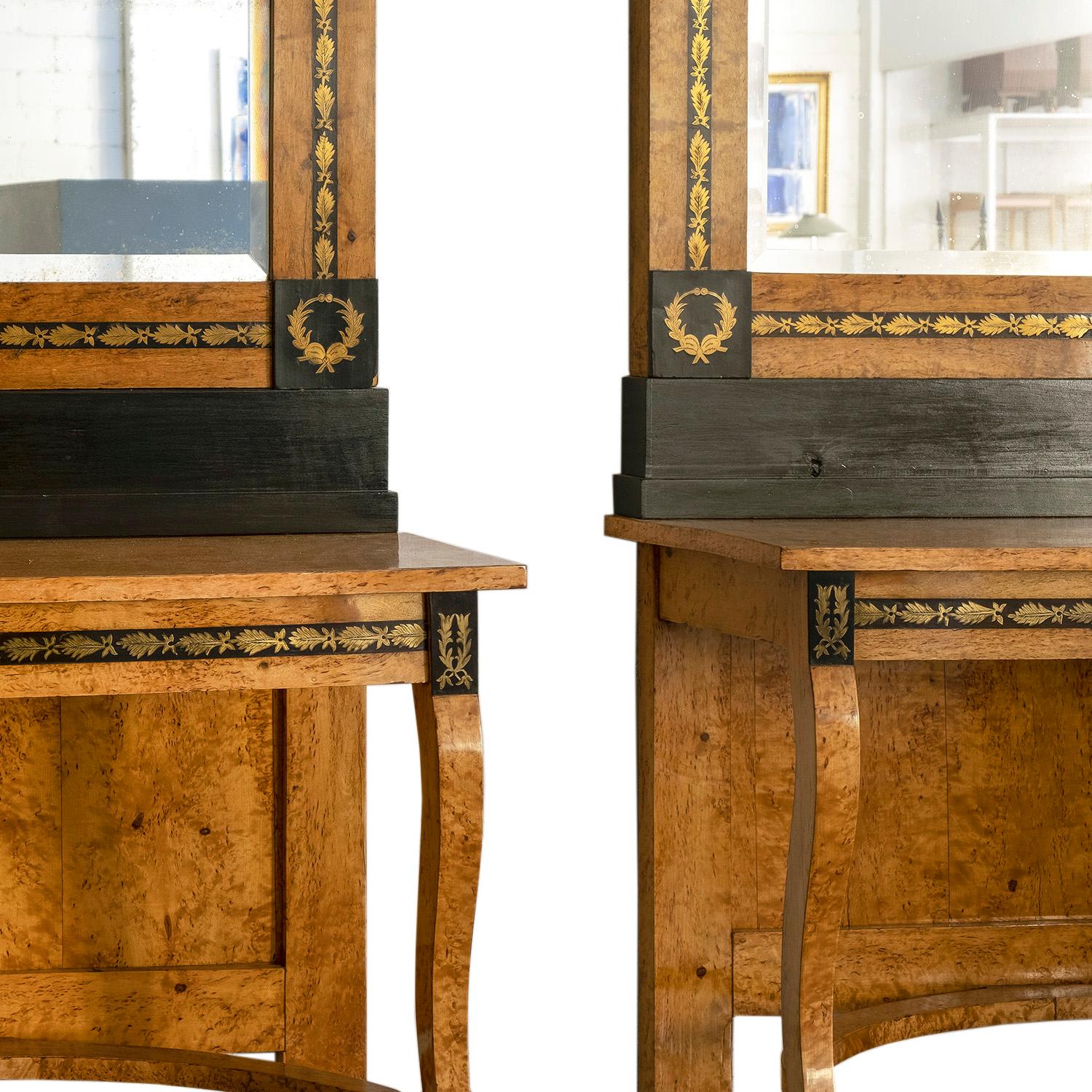 An antique Russian pair of wall mirrors and console tables, nightstands made of hand crafted Karelian Beechwood in good condition. The floor mirrors are supported by two arched legs with brass inserts and partially ebonized, enhanced by very