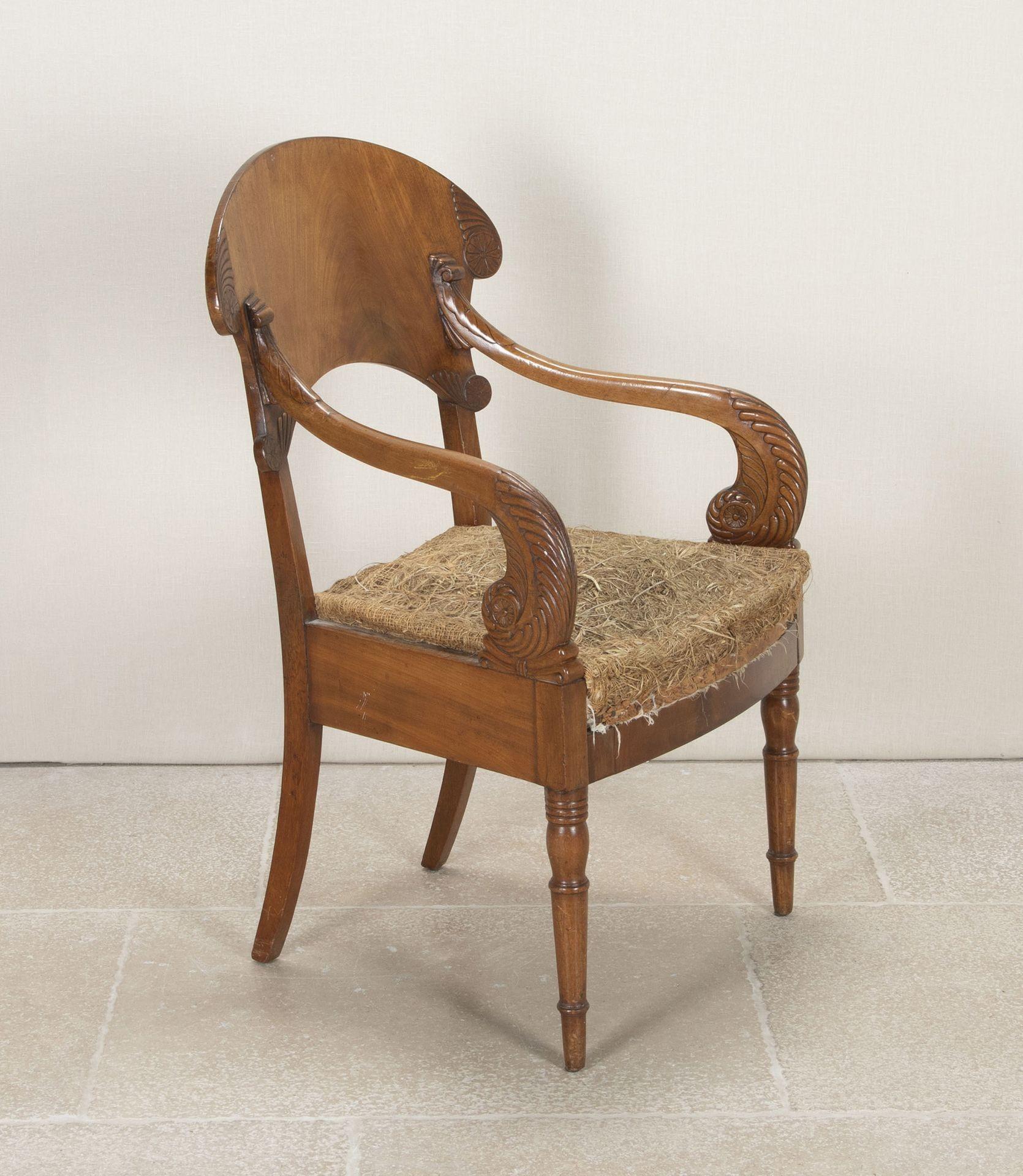 19th Century Russian satinwood open armchair.
With a large arched open backrest with carved scroll design on either side along with a flower rosette. Huge impressive carved scroll arms raised on 2 front turned legs, square back legs with a kick