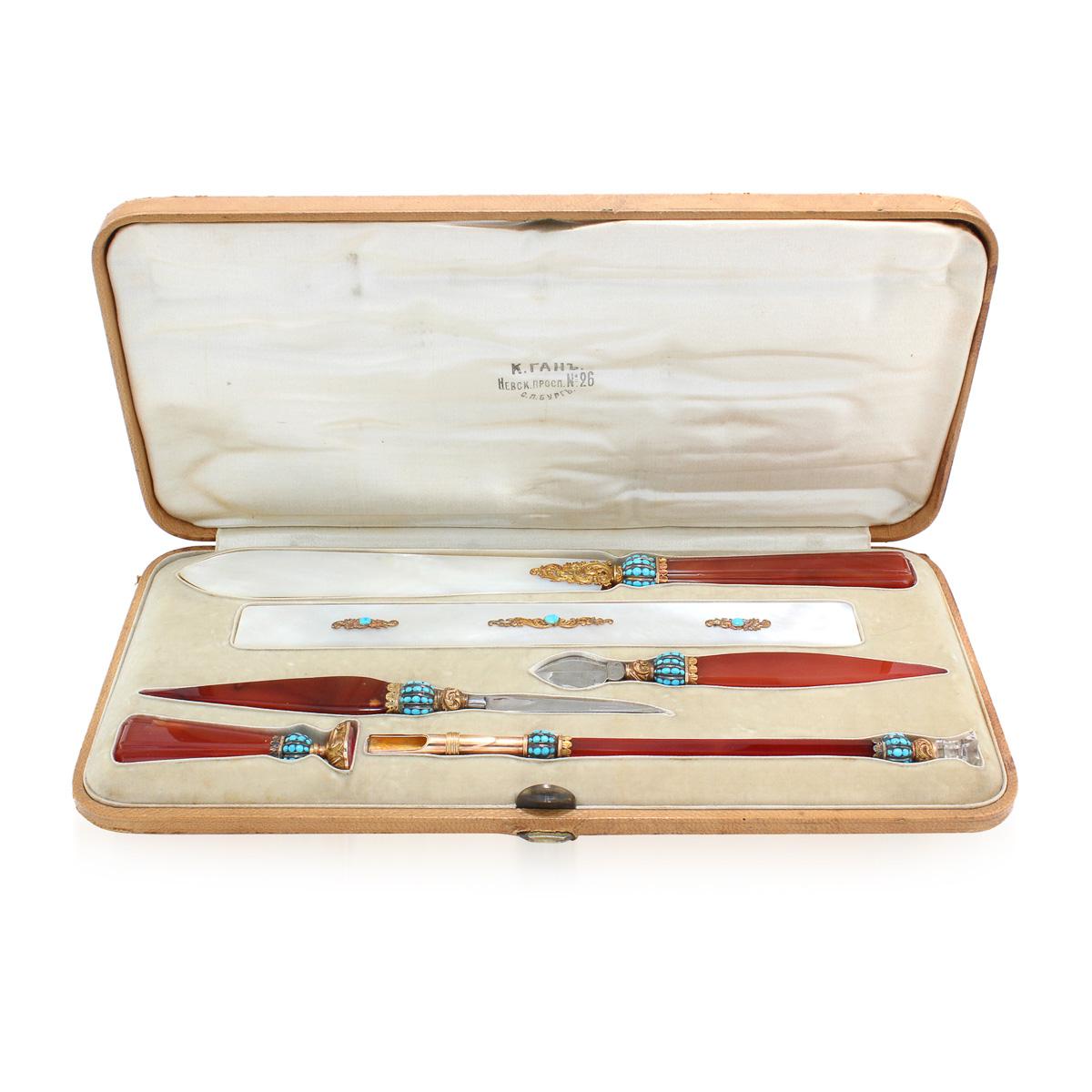 19th century Imperial Russian gold, carnelian, turquoise and mother of pearl desk set, comprising various writing instruments, beautifully decorated with stylised scrolling foliage and fitted in the original retail case.
Retailers mark in Cyrillic