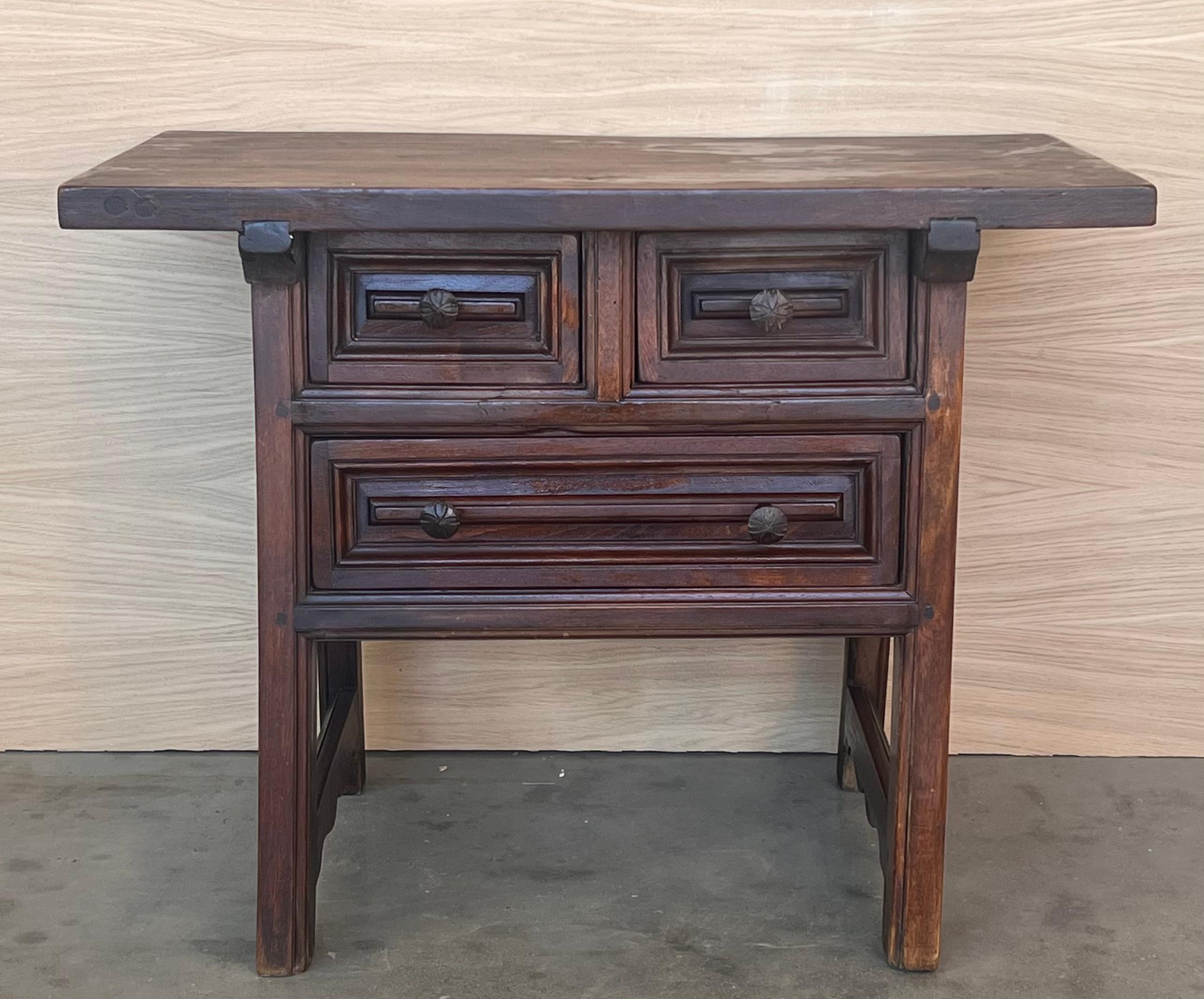 This rustic artisan made side table hails from the Pyrenees on the French-Spanish border. It is constructed from local woods and still boasts original hand forged pulls. Called a 